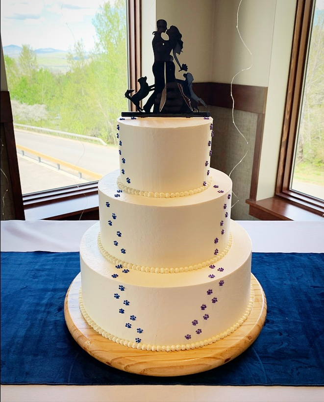 Mix It Up! custom wedding cakes 3 tier cake with white frosting with blue footprints to the cake topper