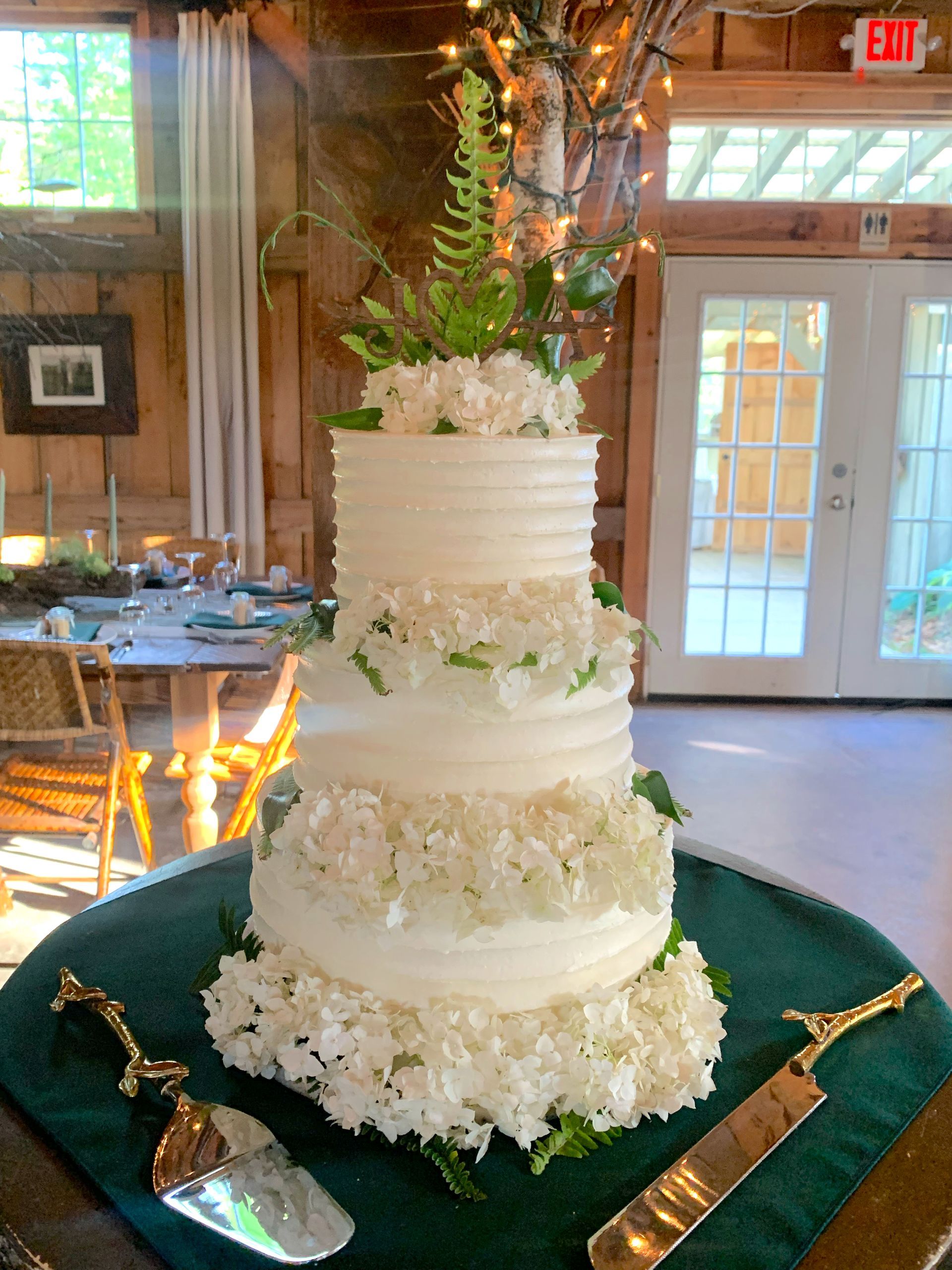 Mix It Up! custom wedding cakes 3 tier white frosting with white flowers