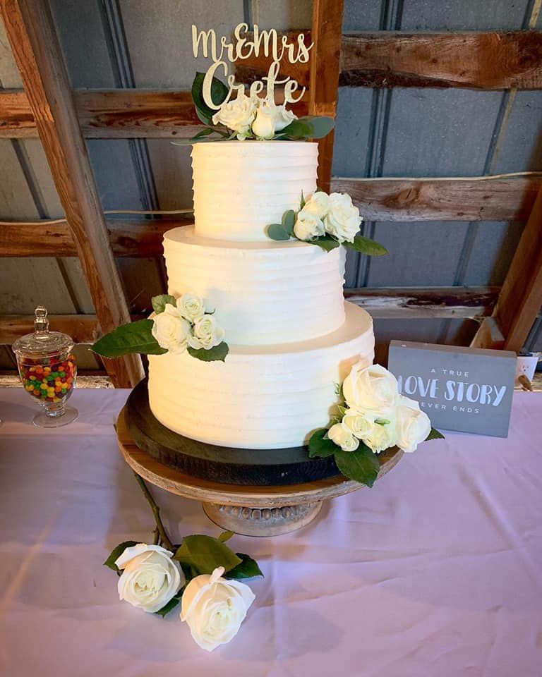 Mix It Up! custom wedding cakes 3 tier cake with white frosting with white flowers on it