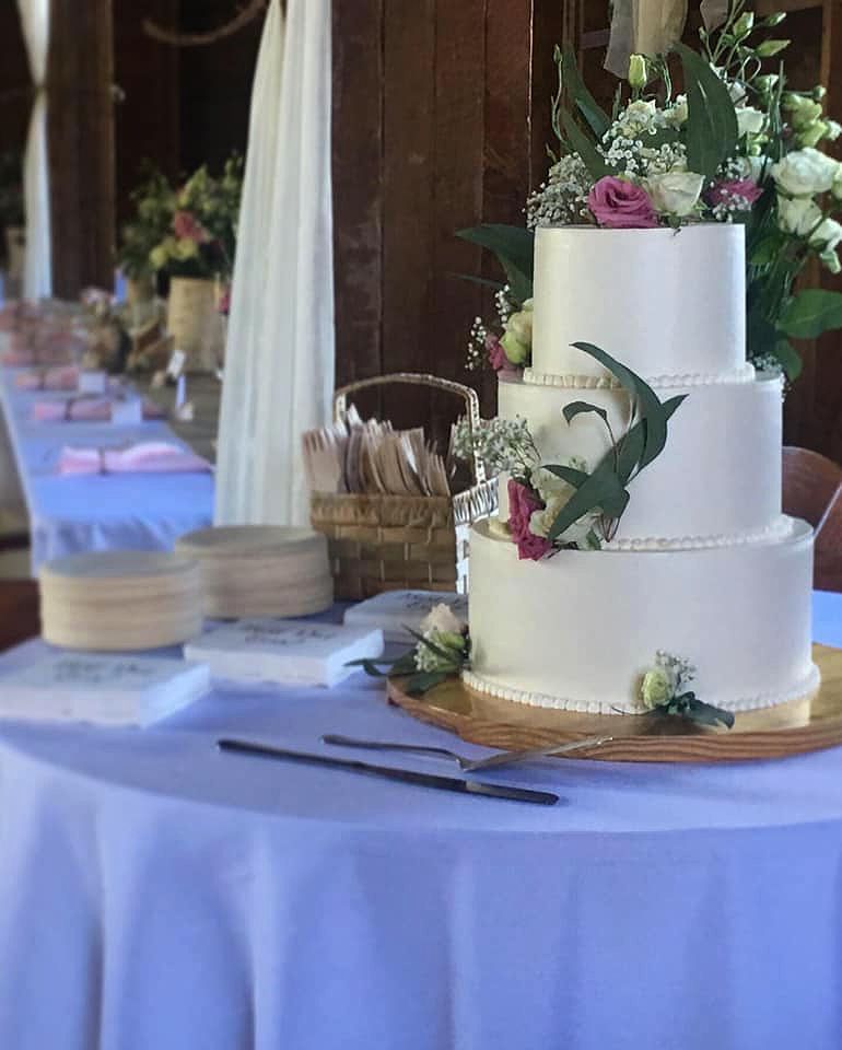 Mix It Up! custom wedding cakes 3 tier white frosting with purple flowers