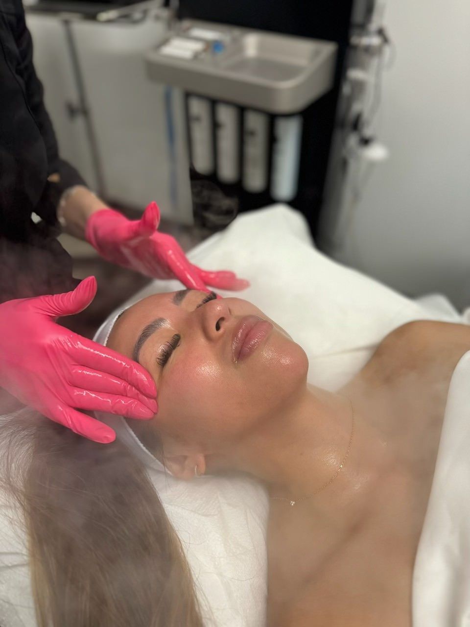 A woman is getting a hydrafacial treatment Huntington Beach