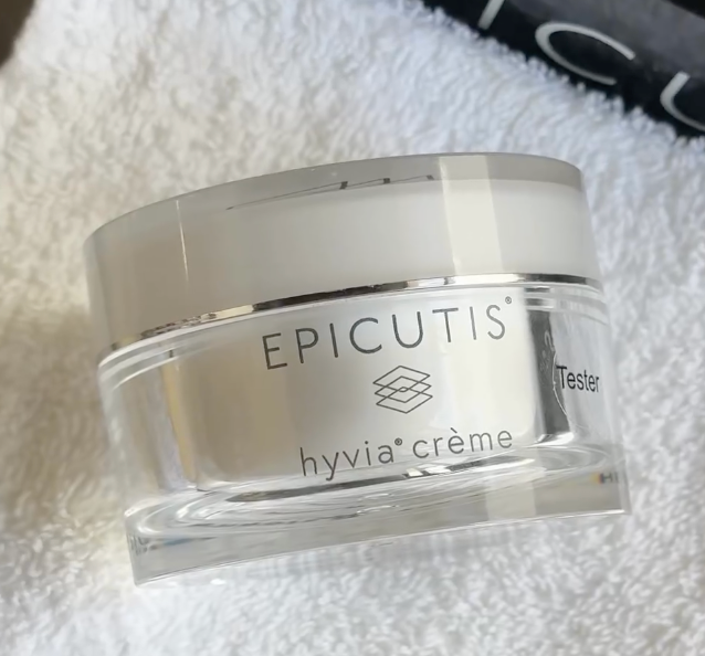 A jar of epicutis hyvia creme is sitting on a white towel