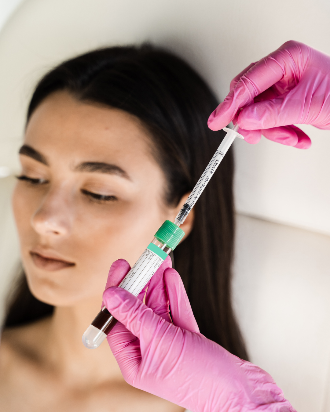 A woman is getting a botox injection in her face.