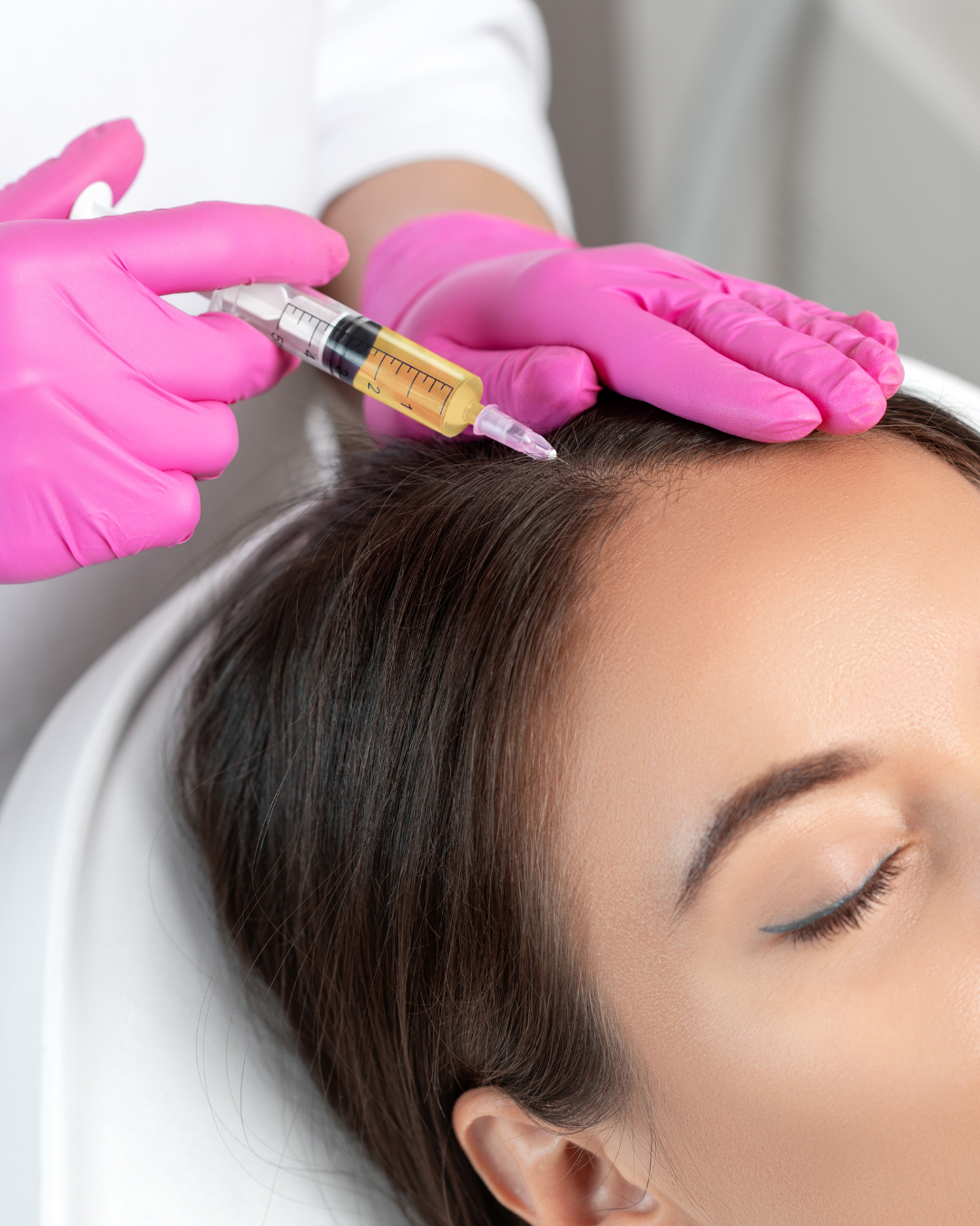 A woman is getting a botox injection in her face.