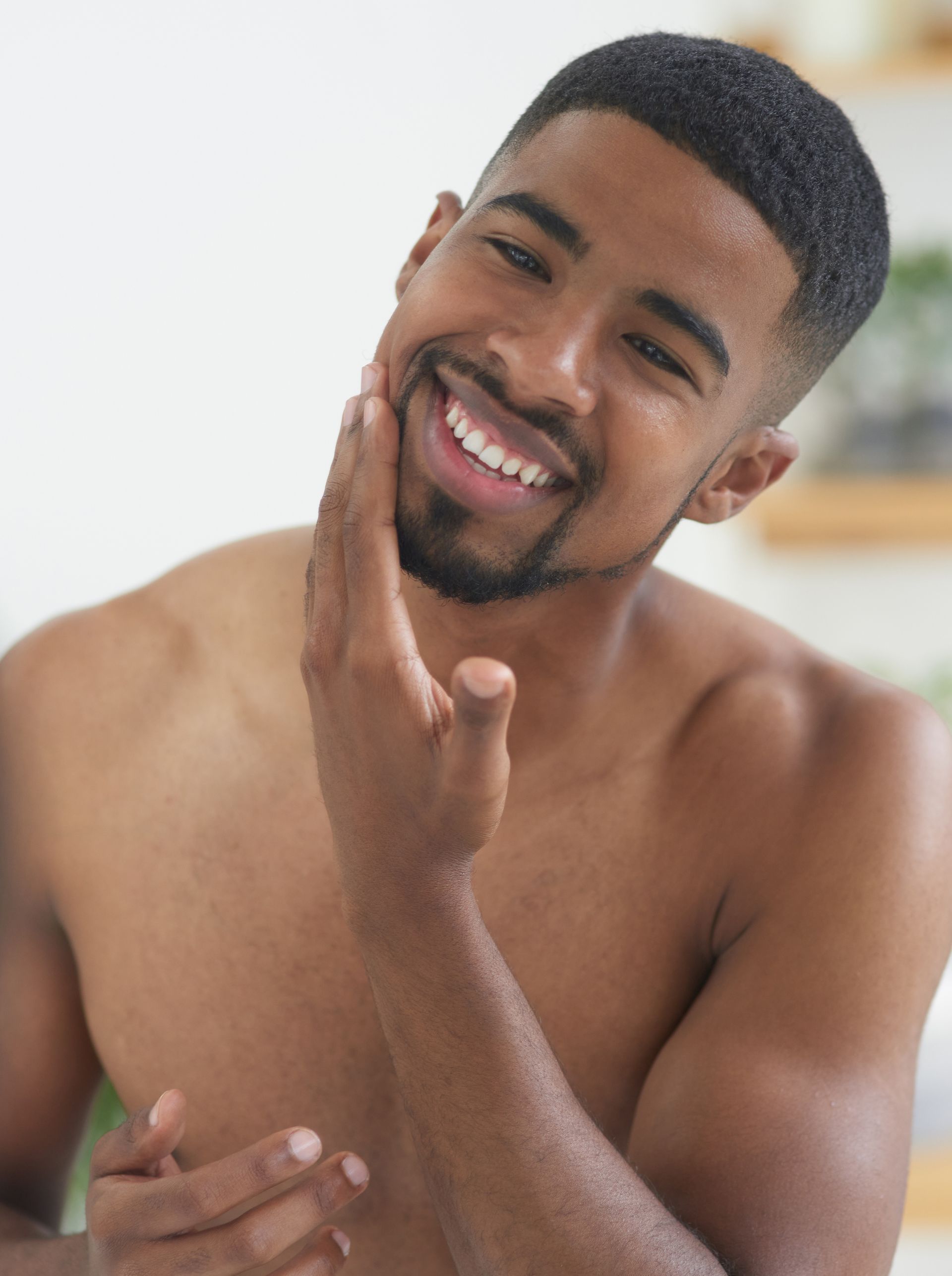 man looking in a mirror and smiling