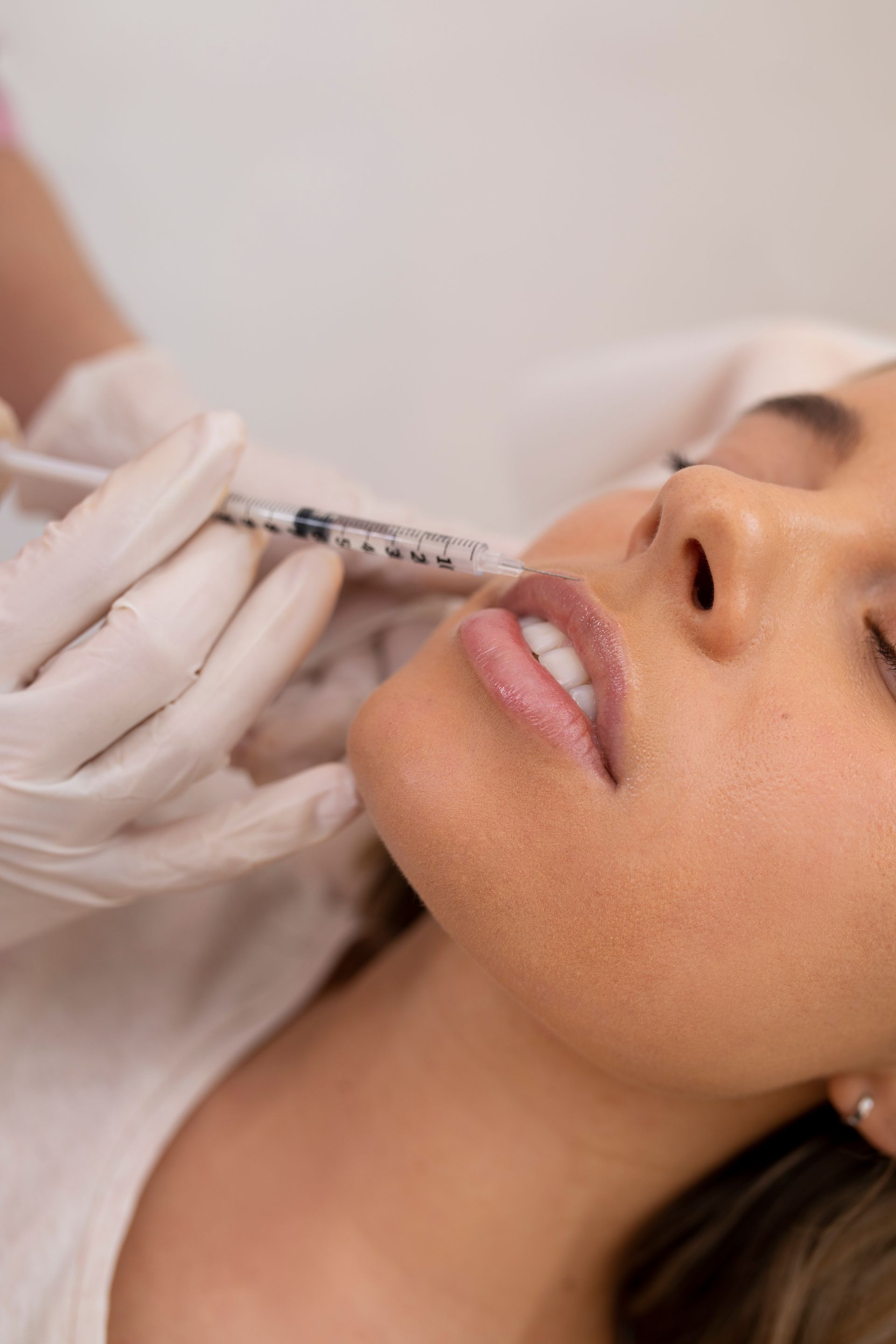 A woman is getting a botox injection in her face.