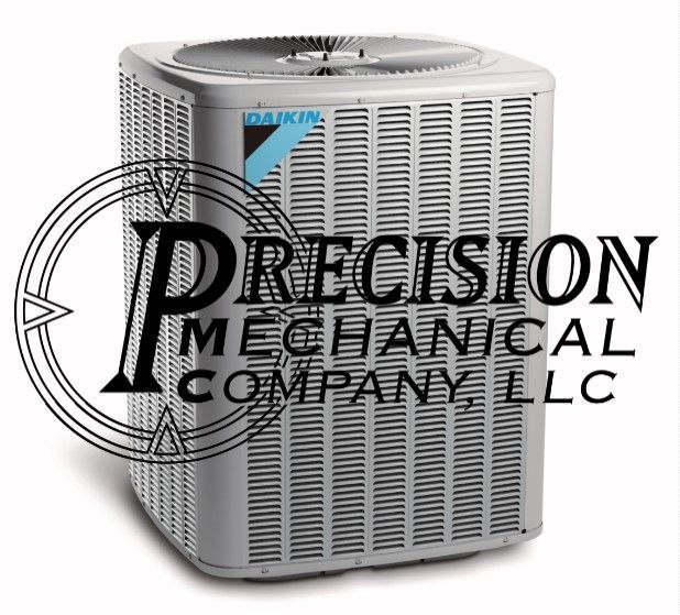 Family in new home: woman, child on couch, man on floor, surrounded by moving boxes and bright window.