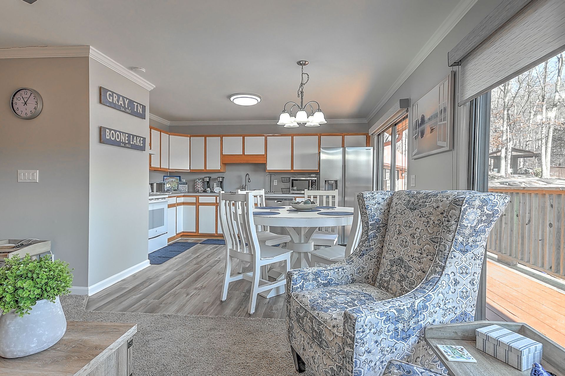 A living room filled with furniture and a clock on the wall.