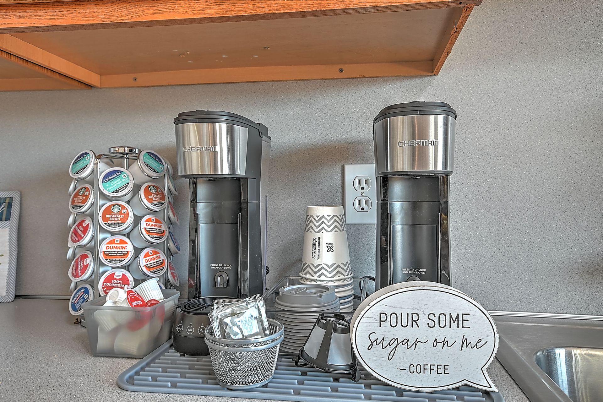 A kitchen with two coffee makers and a sign that says four some