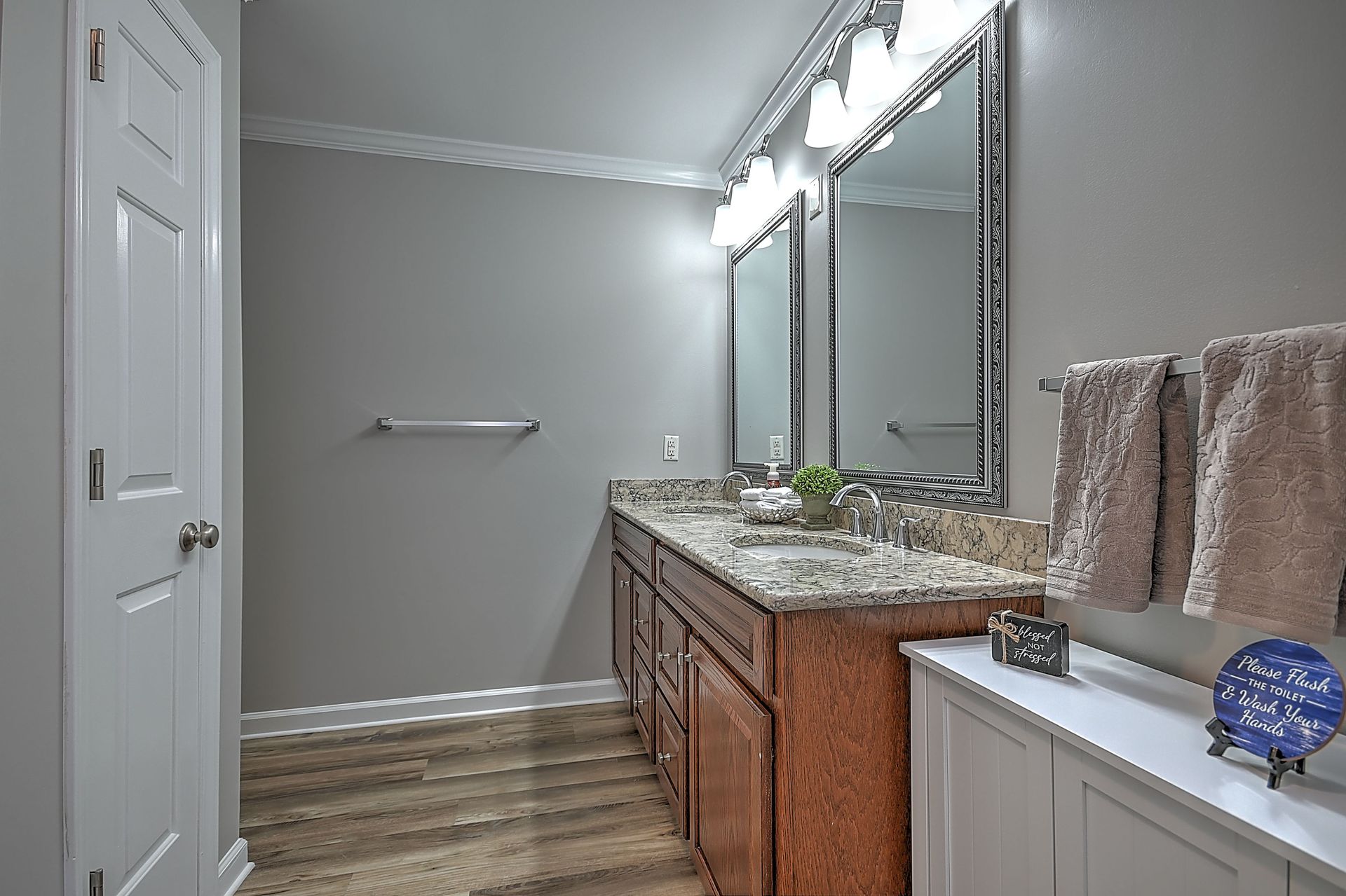 A bathroom with two sinks and two mirrors.