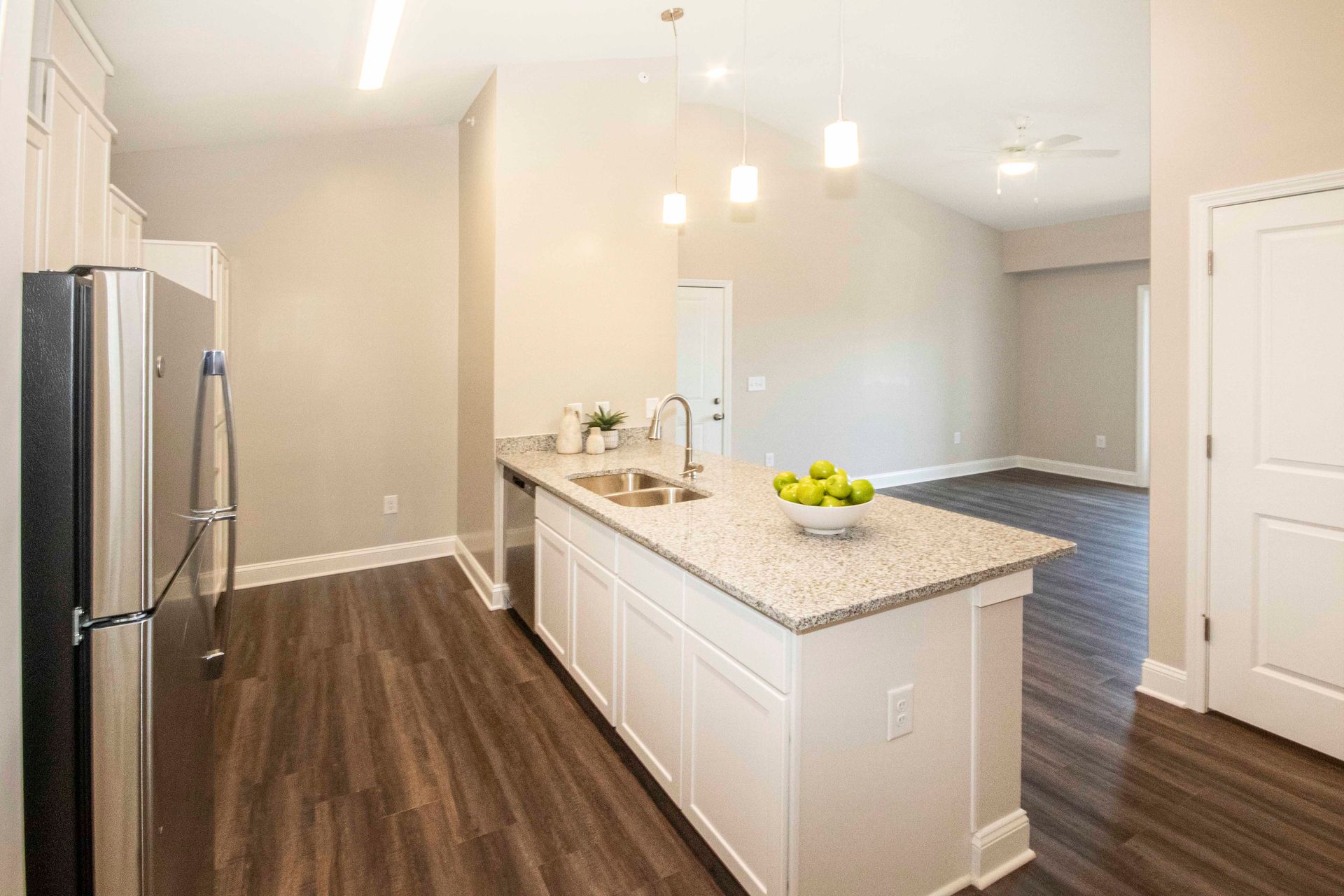 A kitchen with stainless steel appliances , granite counter tops , and a large island.