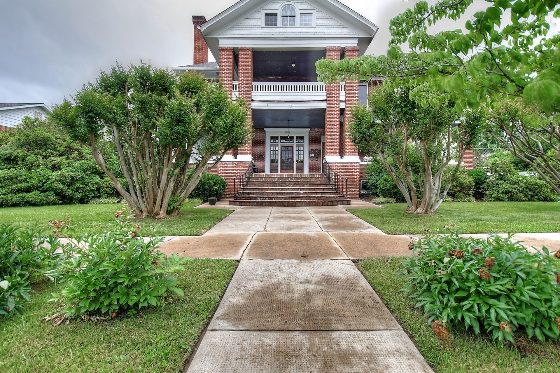 A brick house with a walkway leading to it