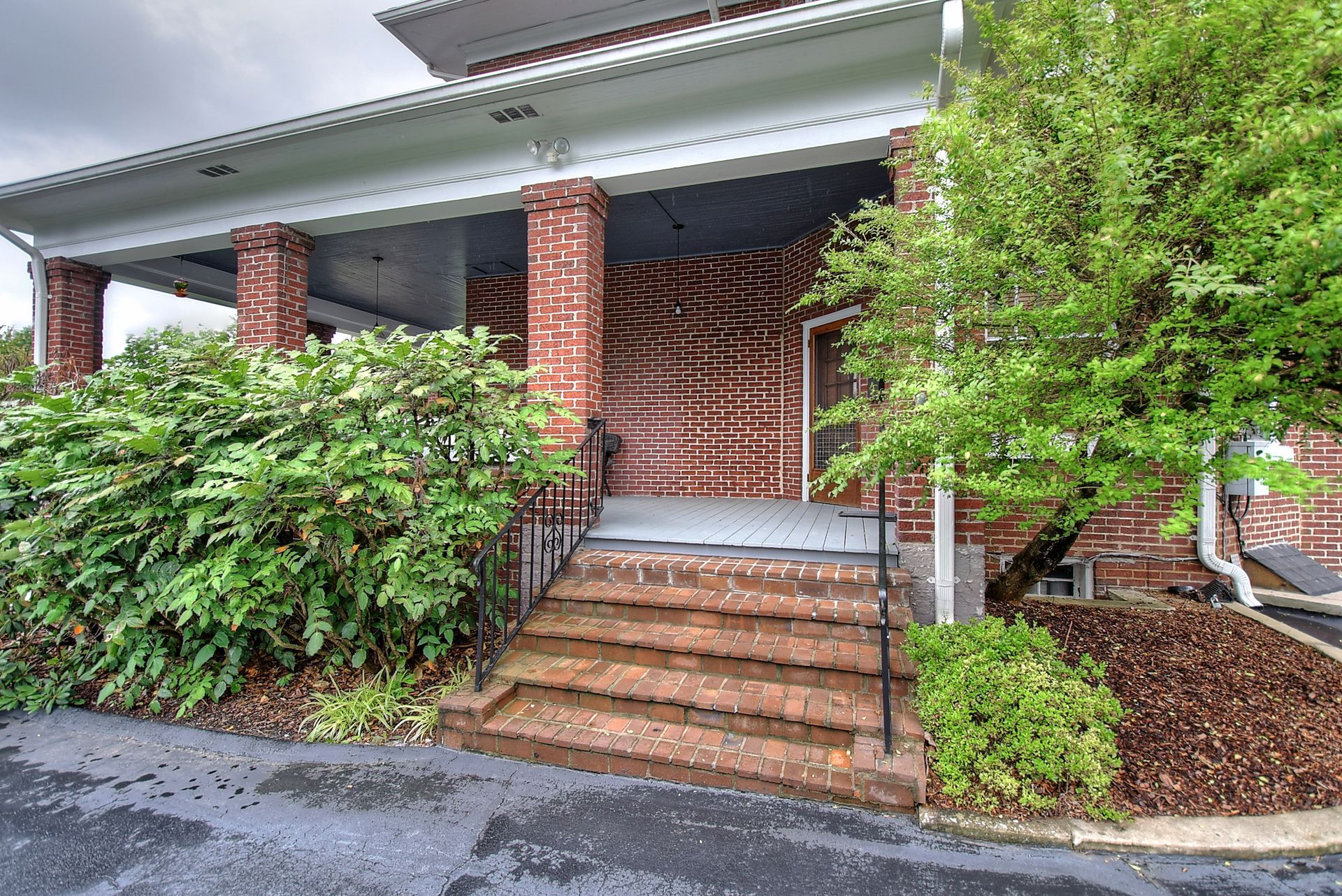 A brick building with stairs leading up to it