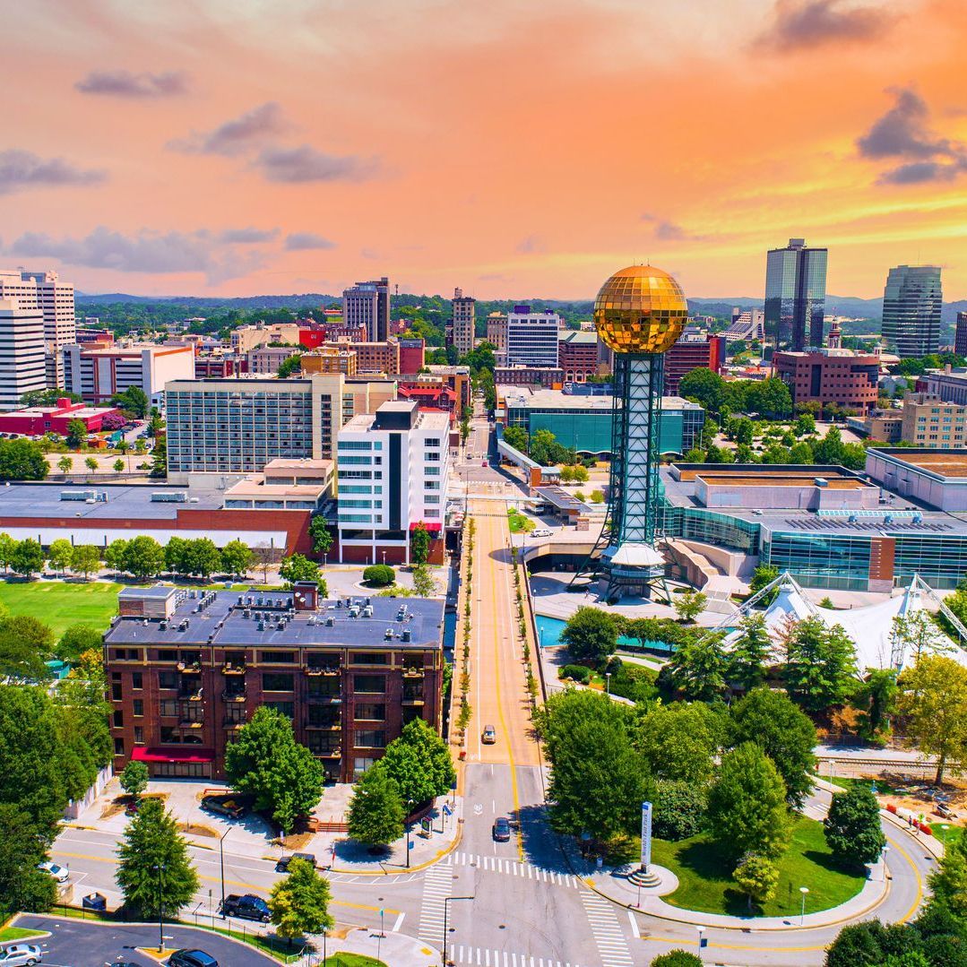 An aerial view of a city with a large ball in the middle of the city.