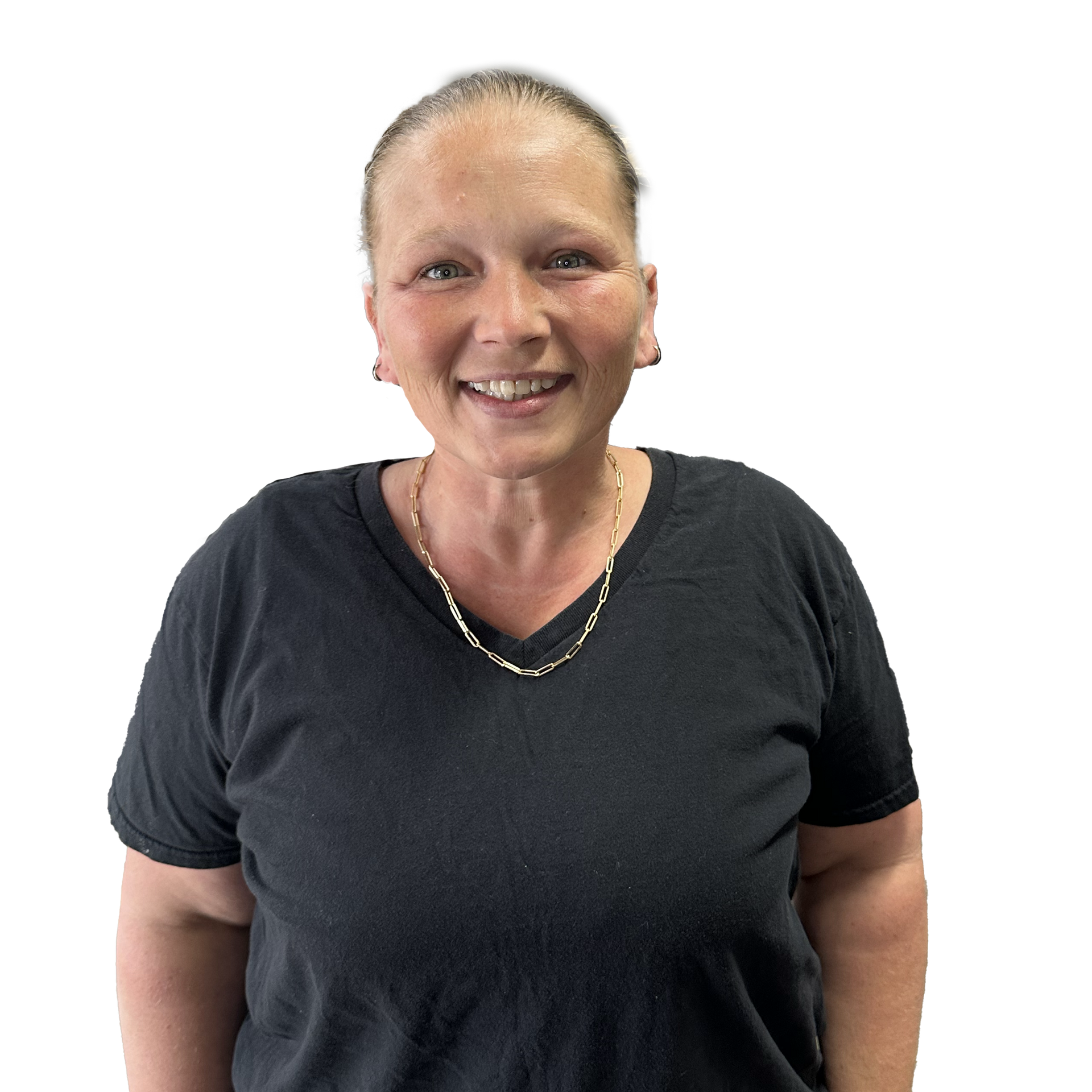 A woman wearing a black shirt and a necklace is smiling for the camera.