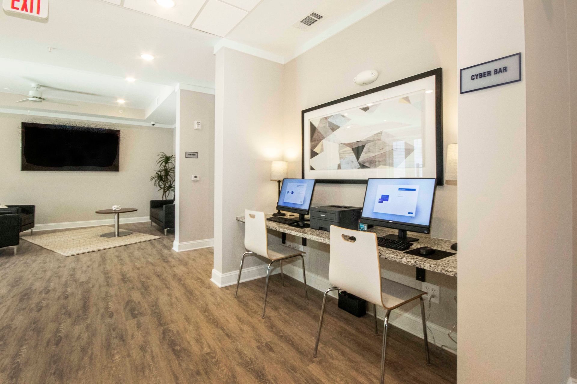 A room with two desks and two computers in it.