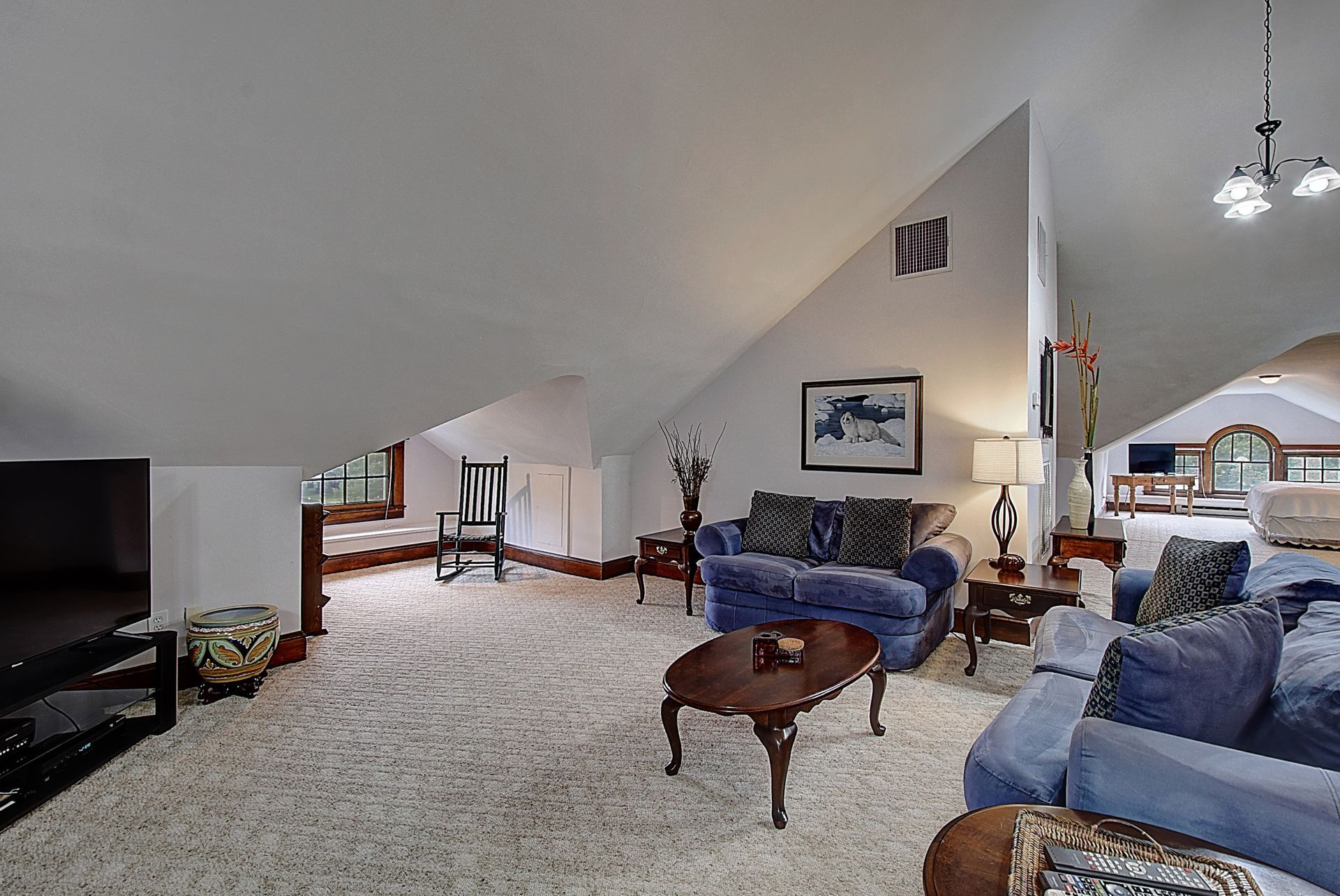 A living room with a couch , coffee table and television