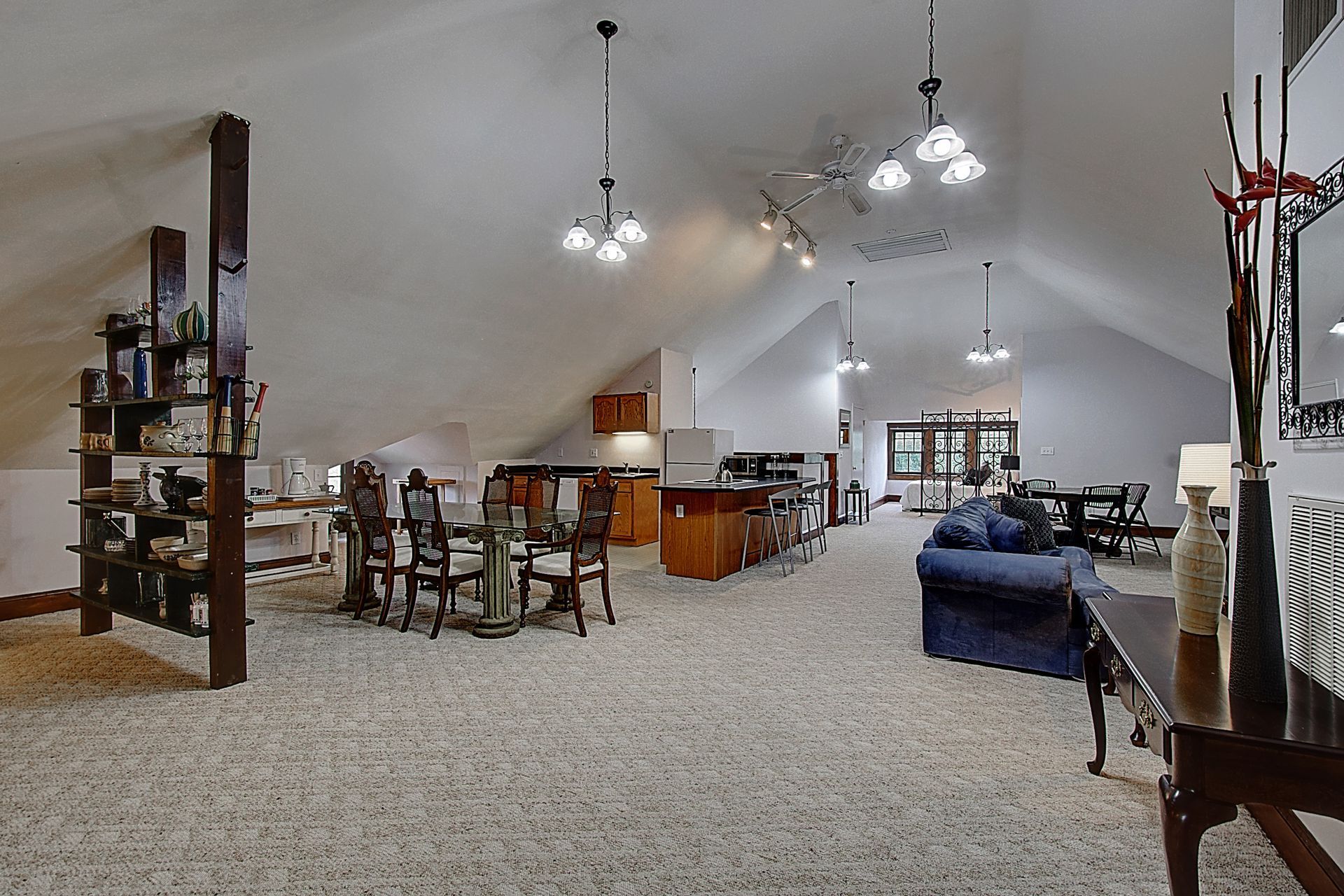A large room with a vaulted ceiling and lots of furniture