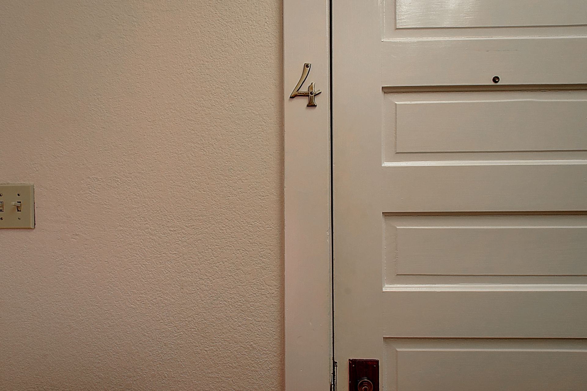 A white door with the number four on it