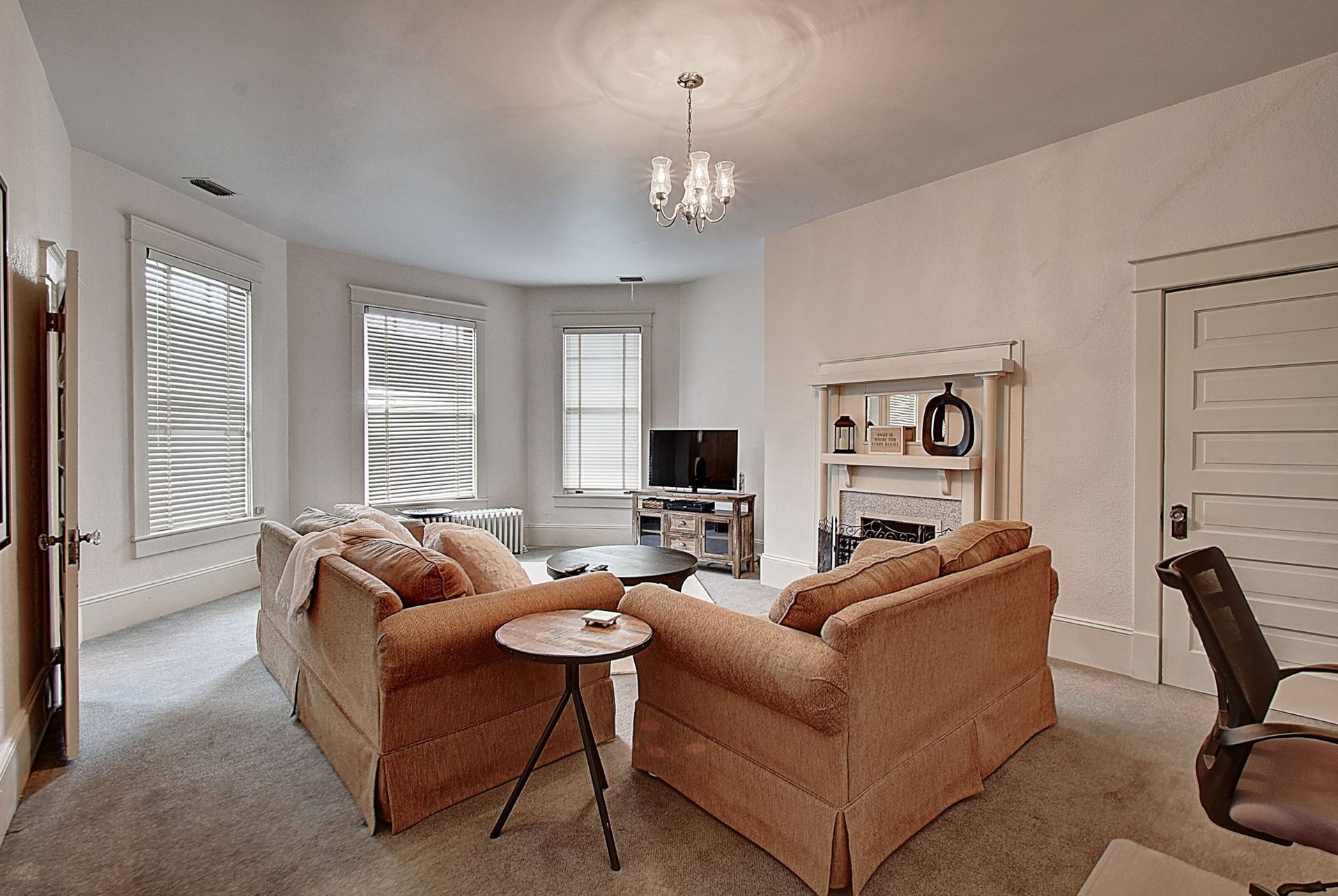 A living room with two couches , a table and a television.