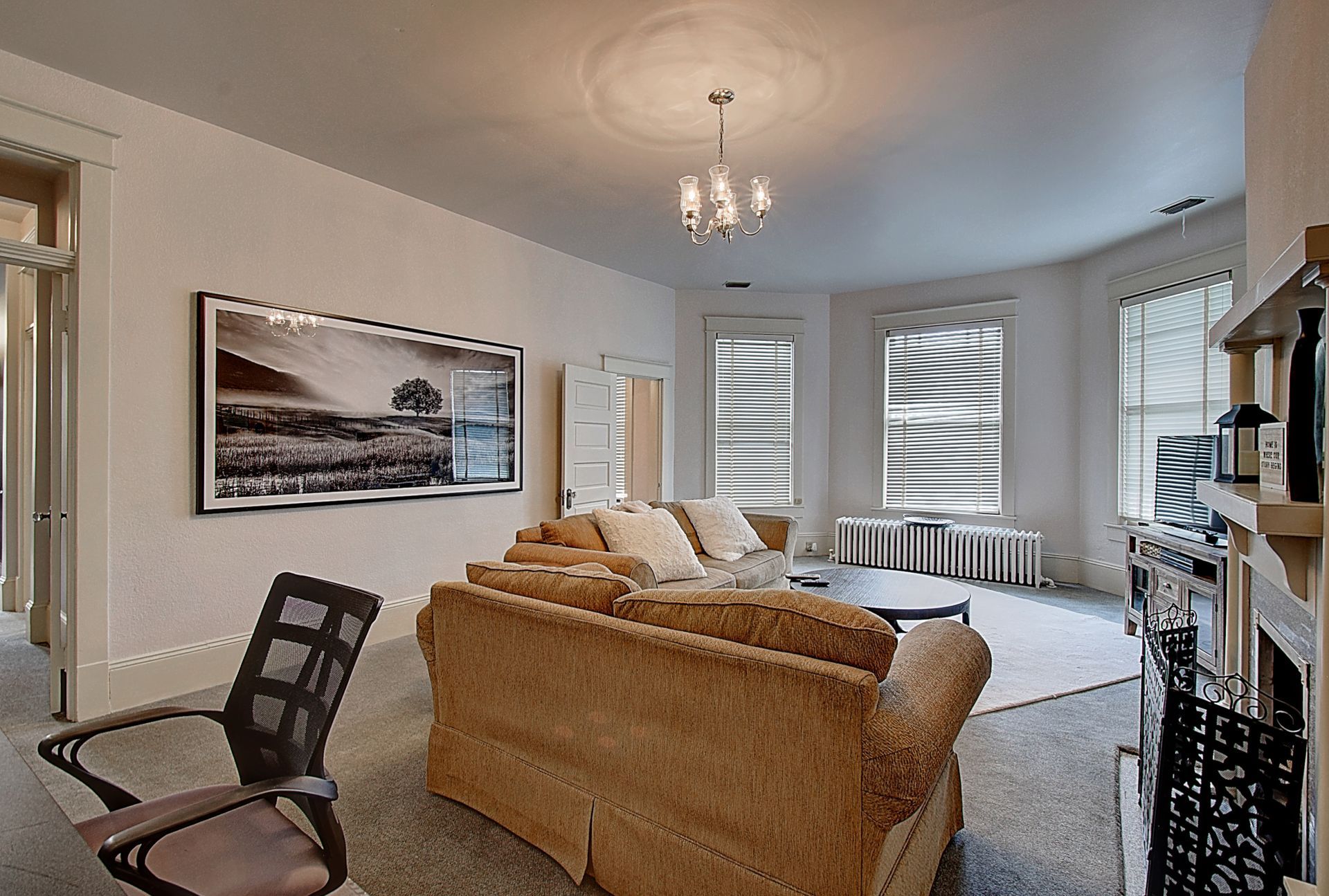 A living room with a couch a chair and a fireplace