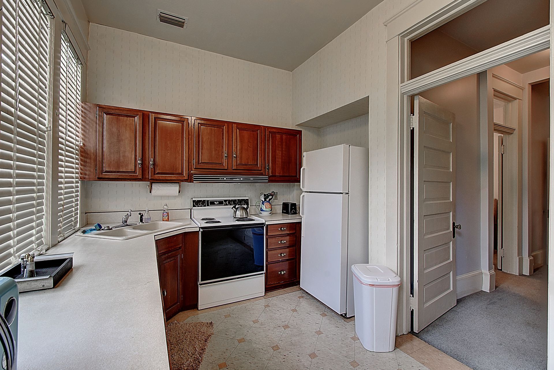 A kitchen with wooden cabinets and a white refrigerator
