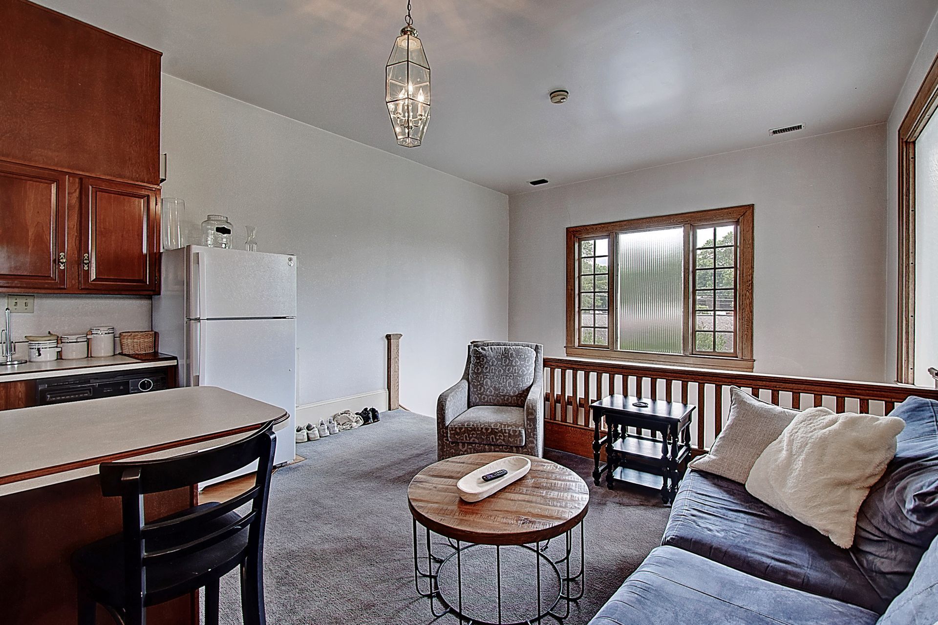 A living room with a couch a chair and a table