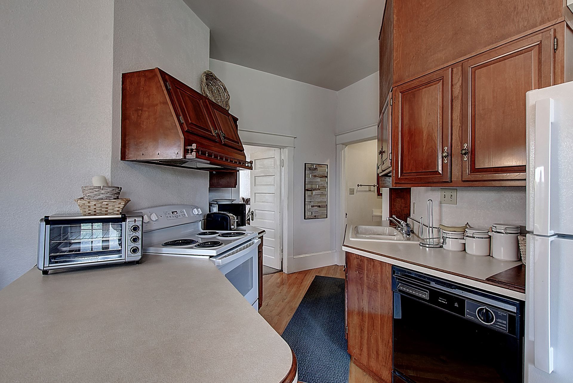 A kitchen with wooden cabinets and a white refrigerator