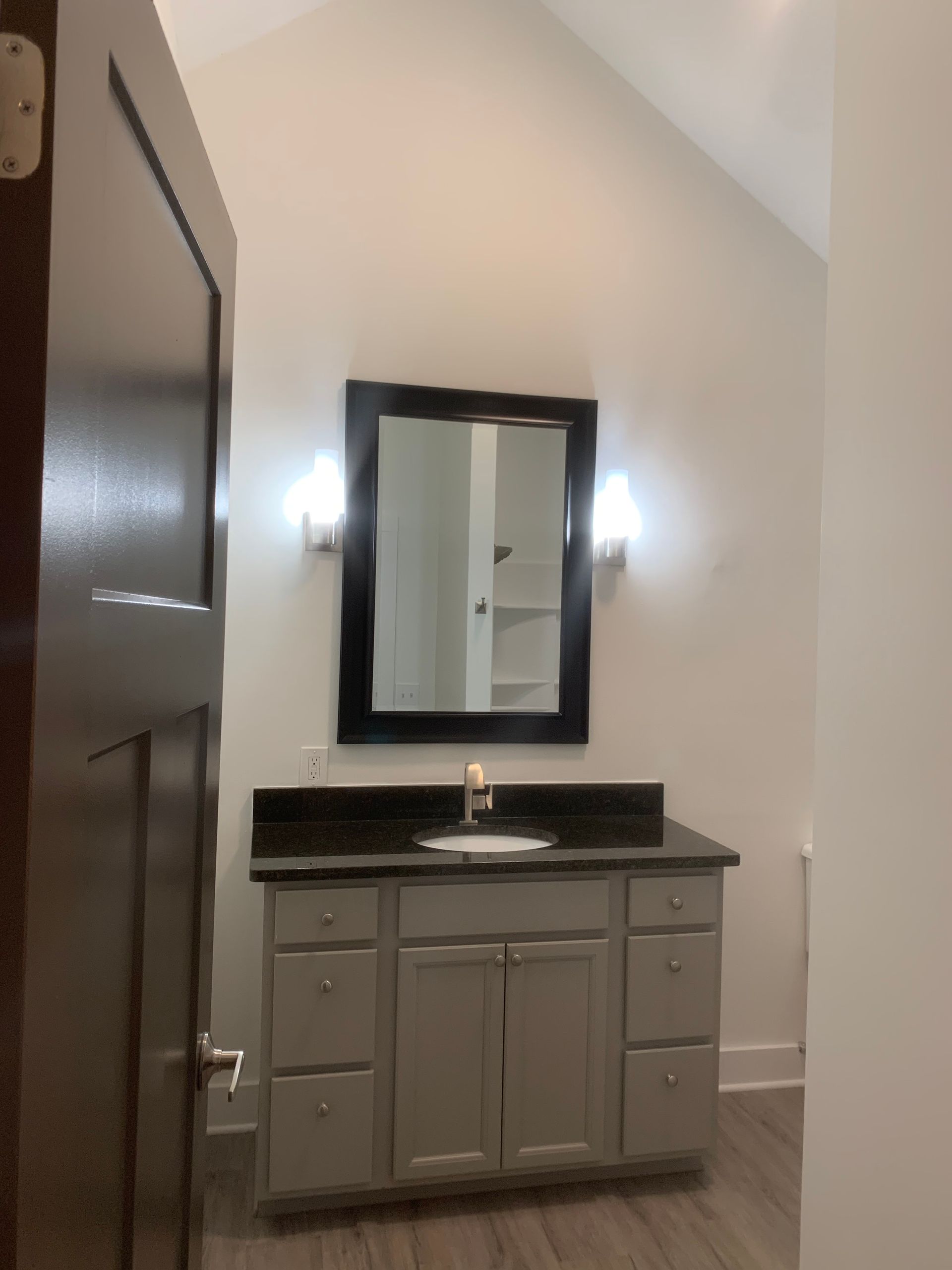 A bathroom with a sink and a mirror on the wall