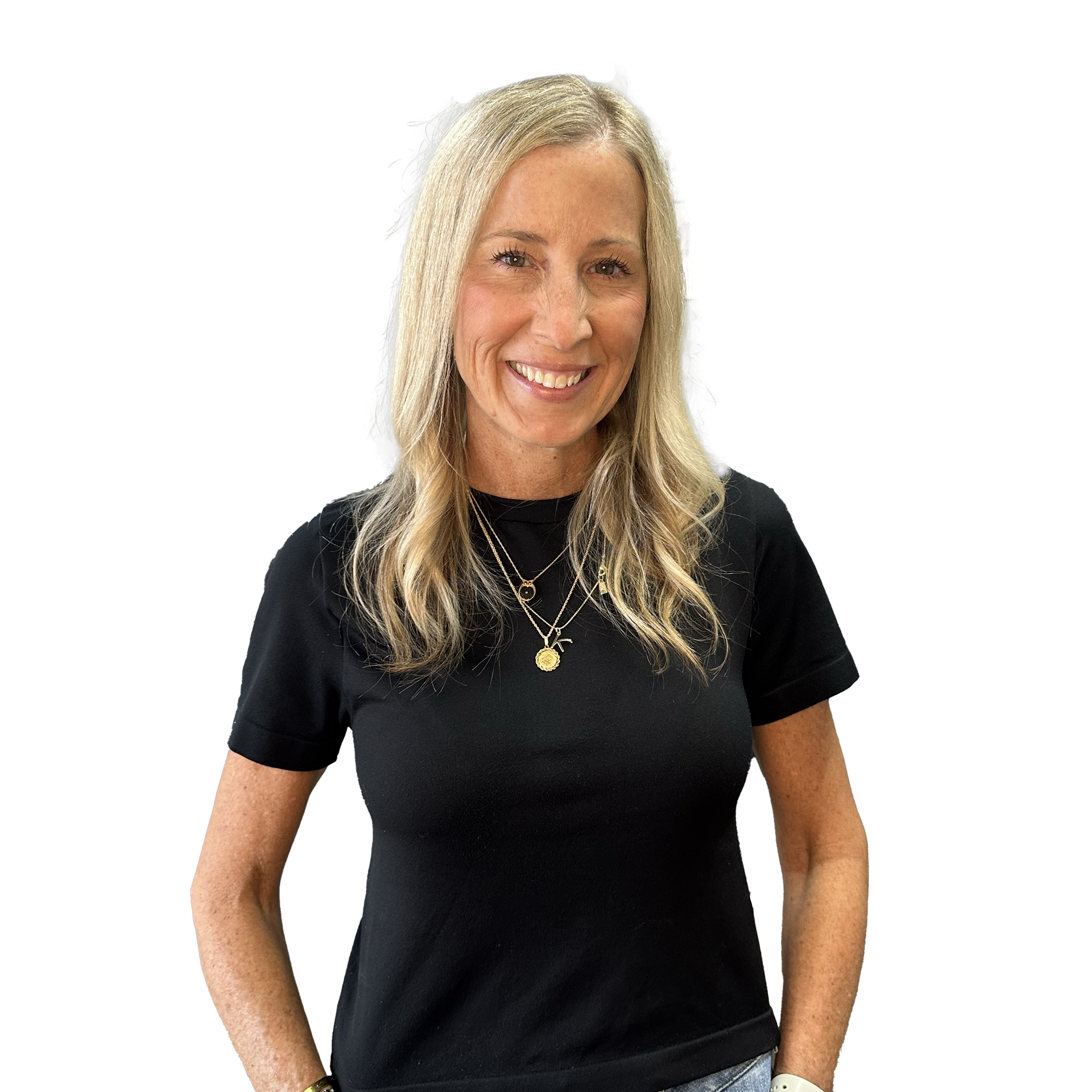 A woman wearing a black shirt and a necklace is smiling.