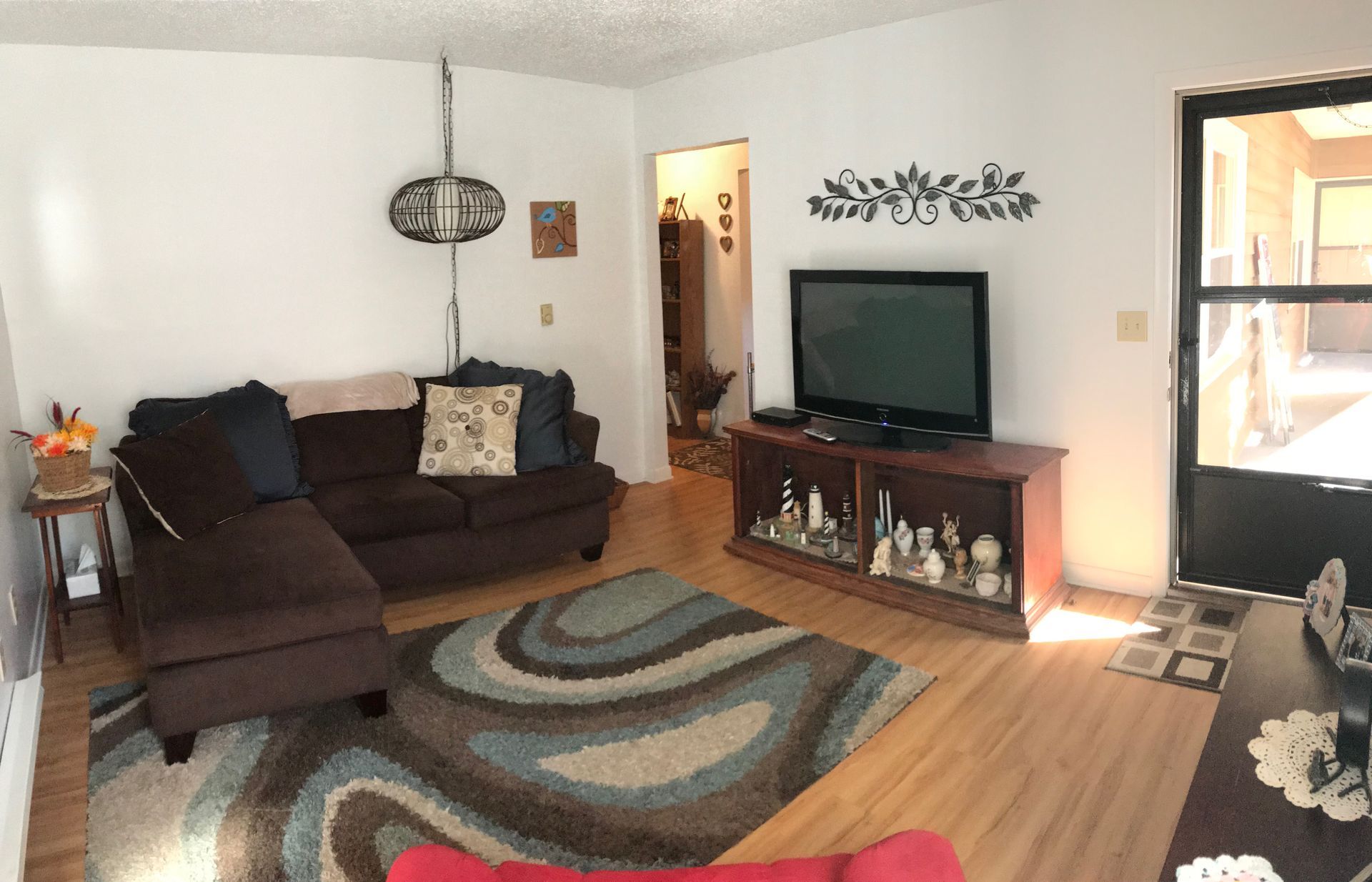 A living room with a couch and a flat screen tv