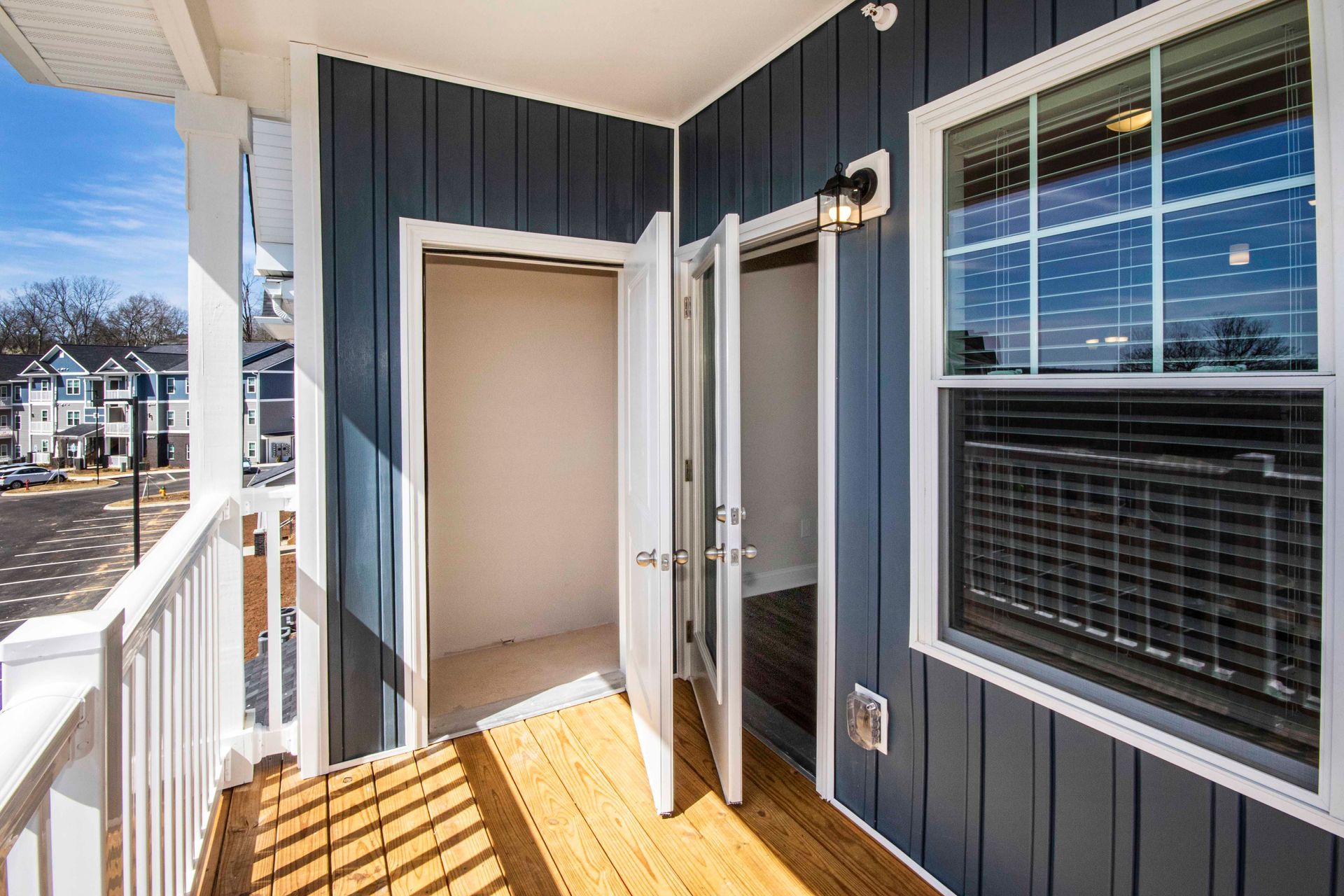 A balcony with a closet and a window in a house.