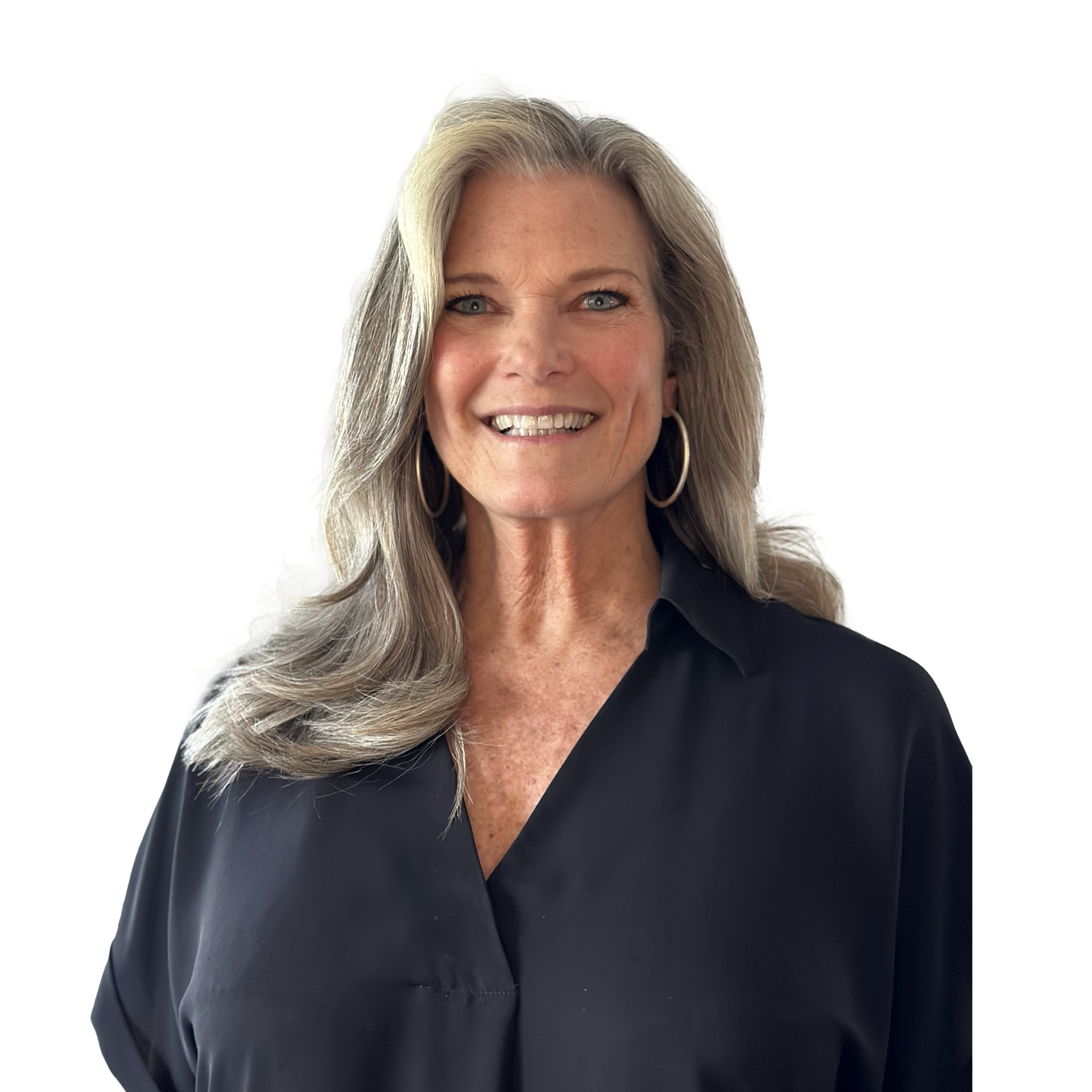 A woman wearing a black shirt and earrings is smiling for the camera.