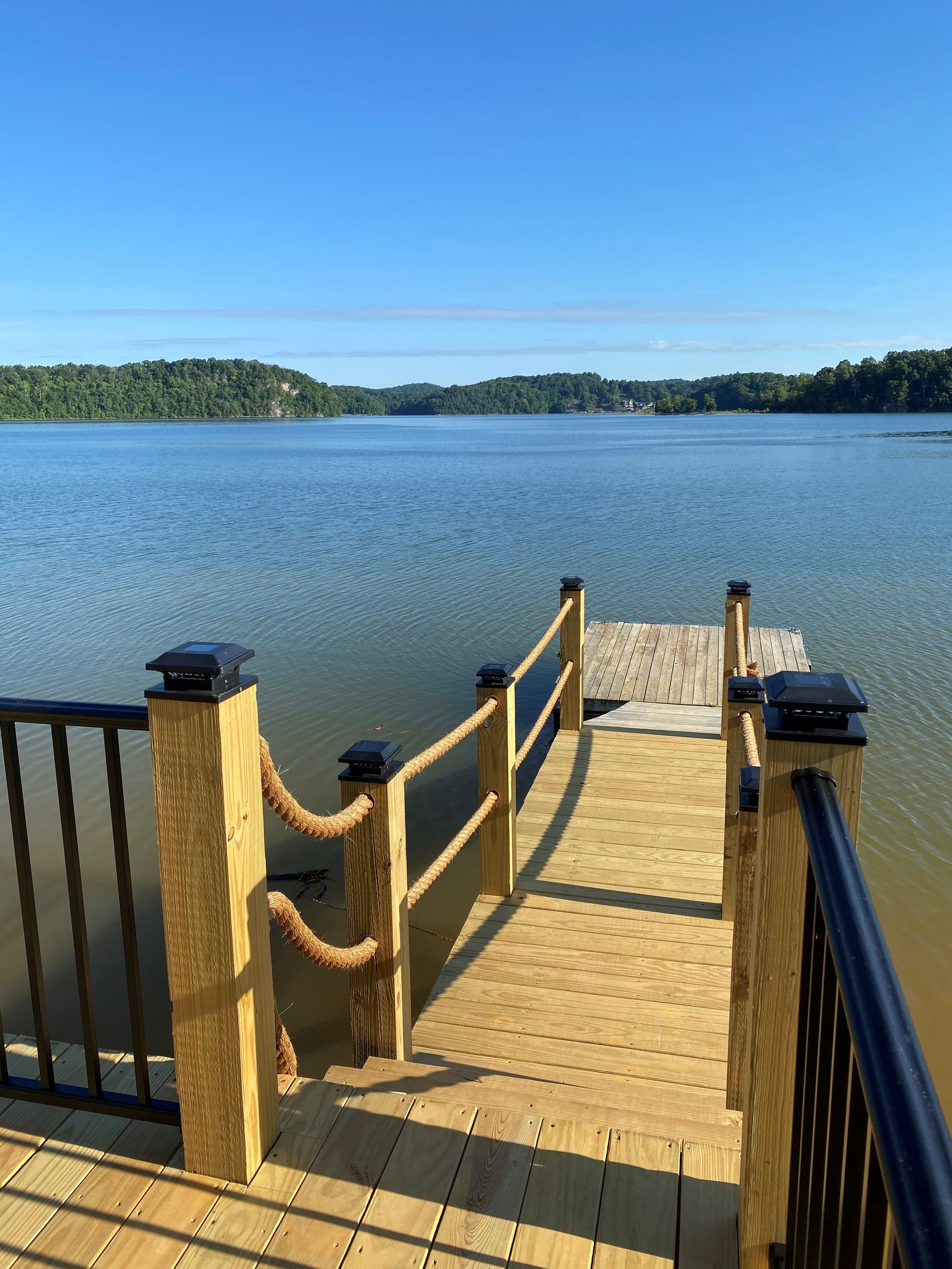 A wooden dock leading to a large body of water.