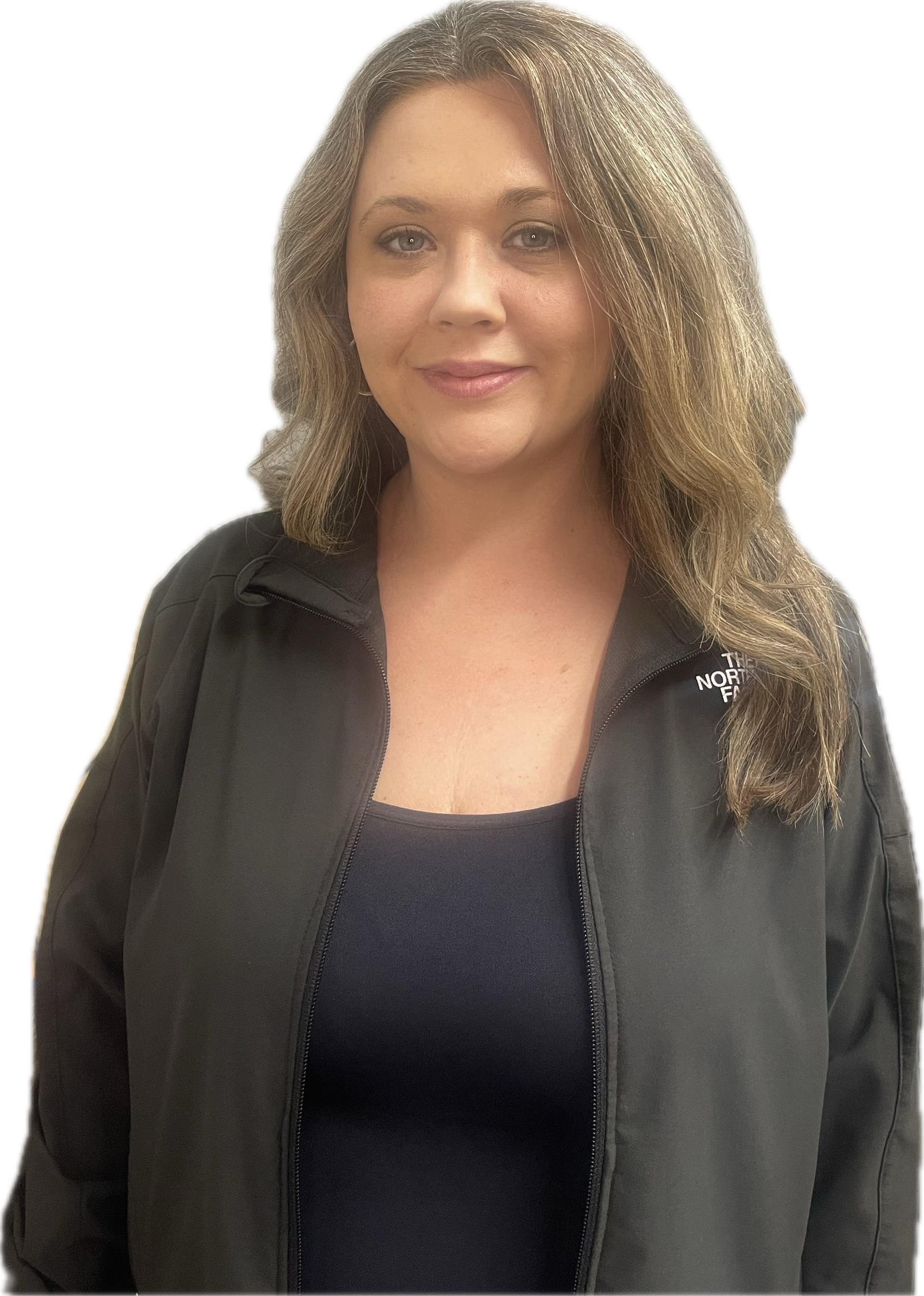 A woman with curly hair is wearing a black shirt and smiling.