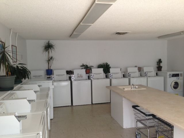 A laundromat with lots of washers and dryers