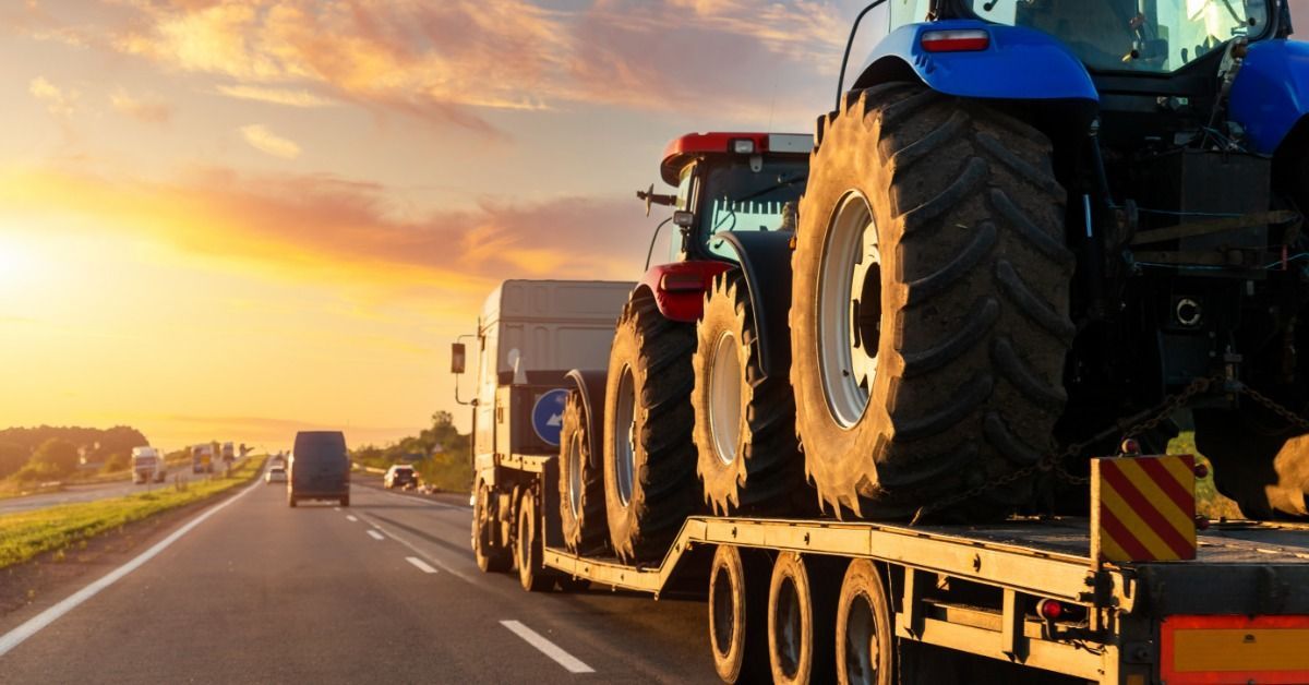 A large semi truck with a flatbed trailer traveling down a highway.