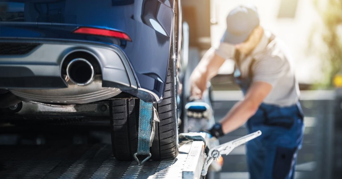  A close-up of the back of a vehicle on a transport trailer.