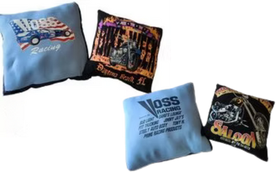 Four square throw pillows with racing or motorcycle graphics.