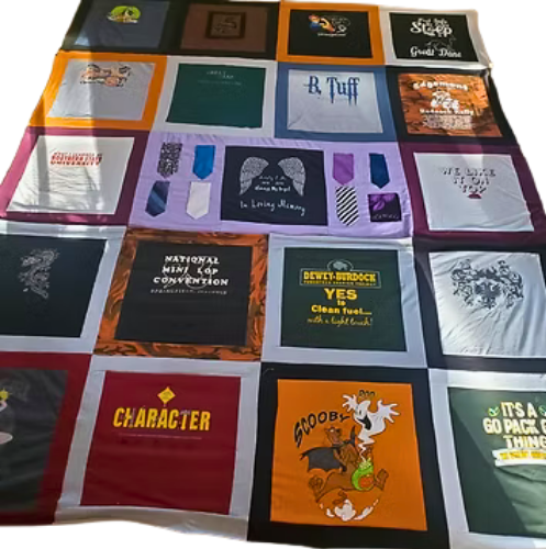 T-shirt quilt with various designs and logos in a patchwork pattern, with black borders.