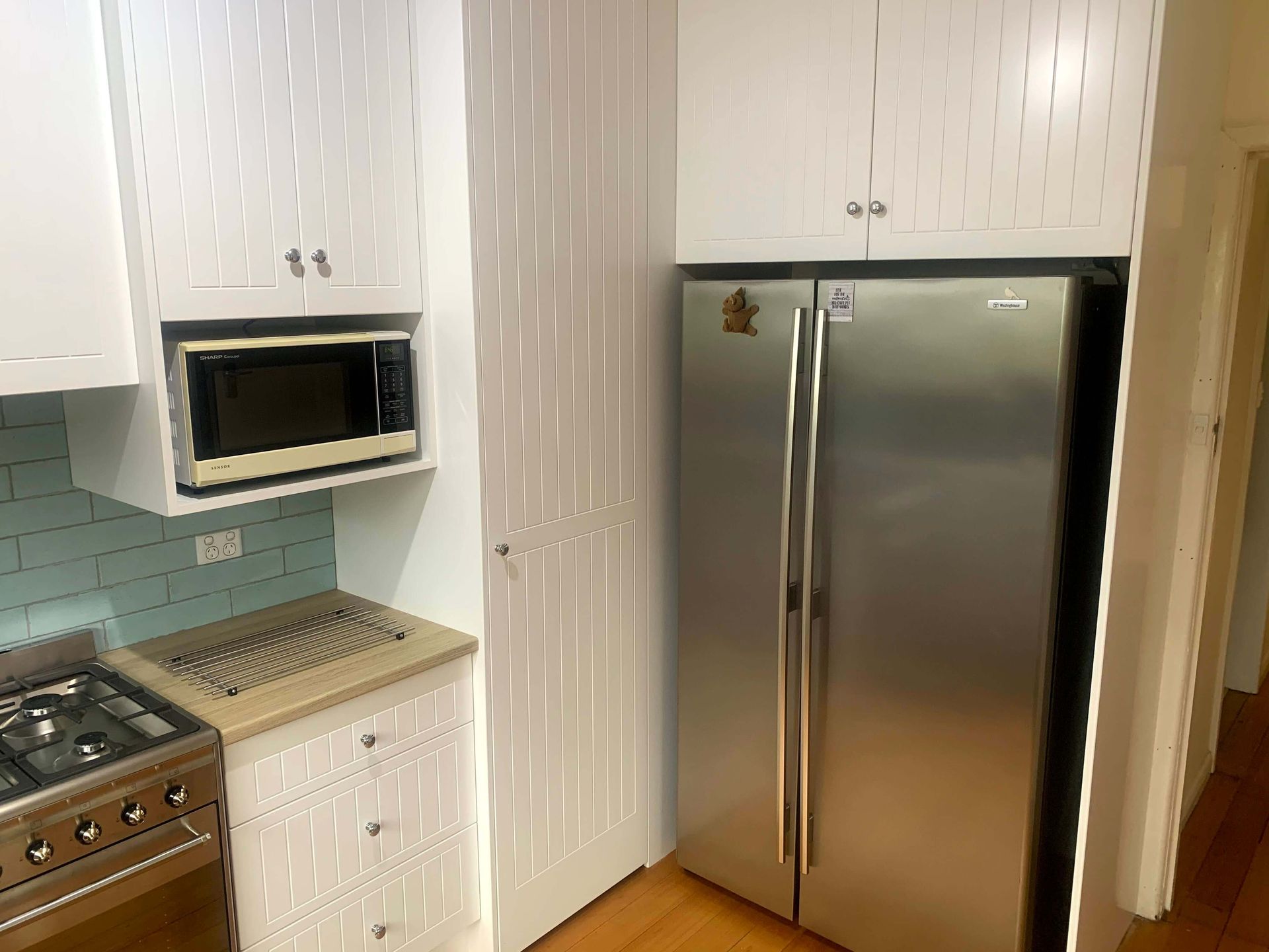 A kitchen with a stainless steel refrigerator , stove , microwave and cabinets.