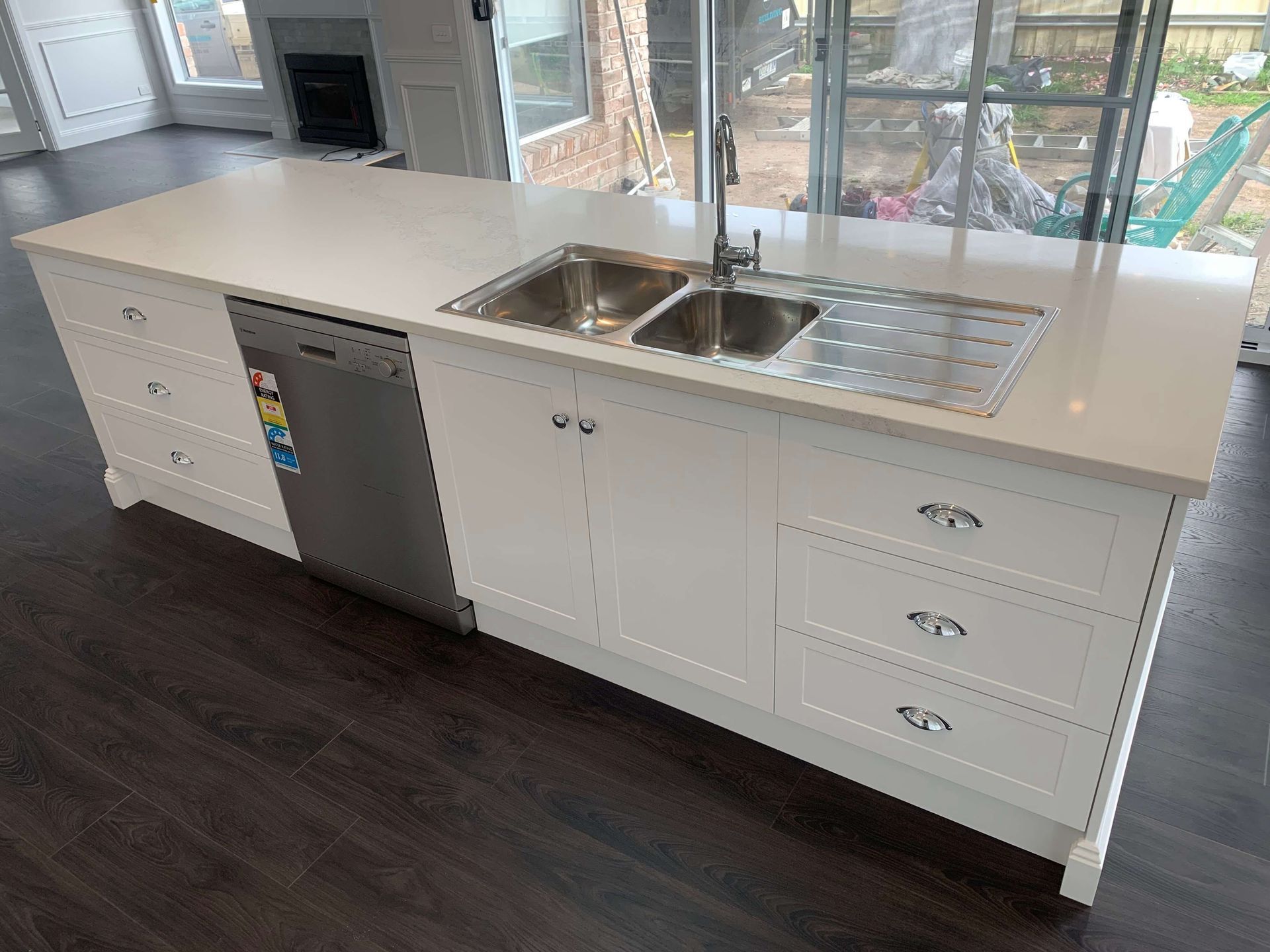 A kitchen with two sinks , a dishwasher , and a large island.