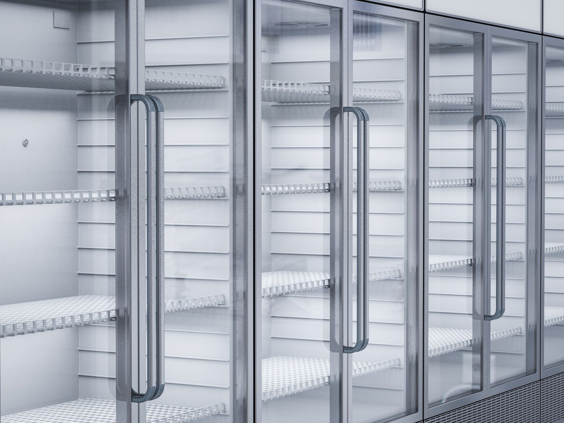 A row of empty refrigerators with glass doors in a store.