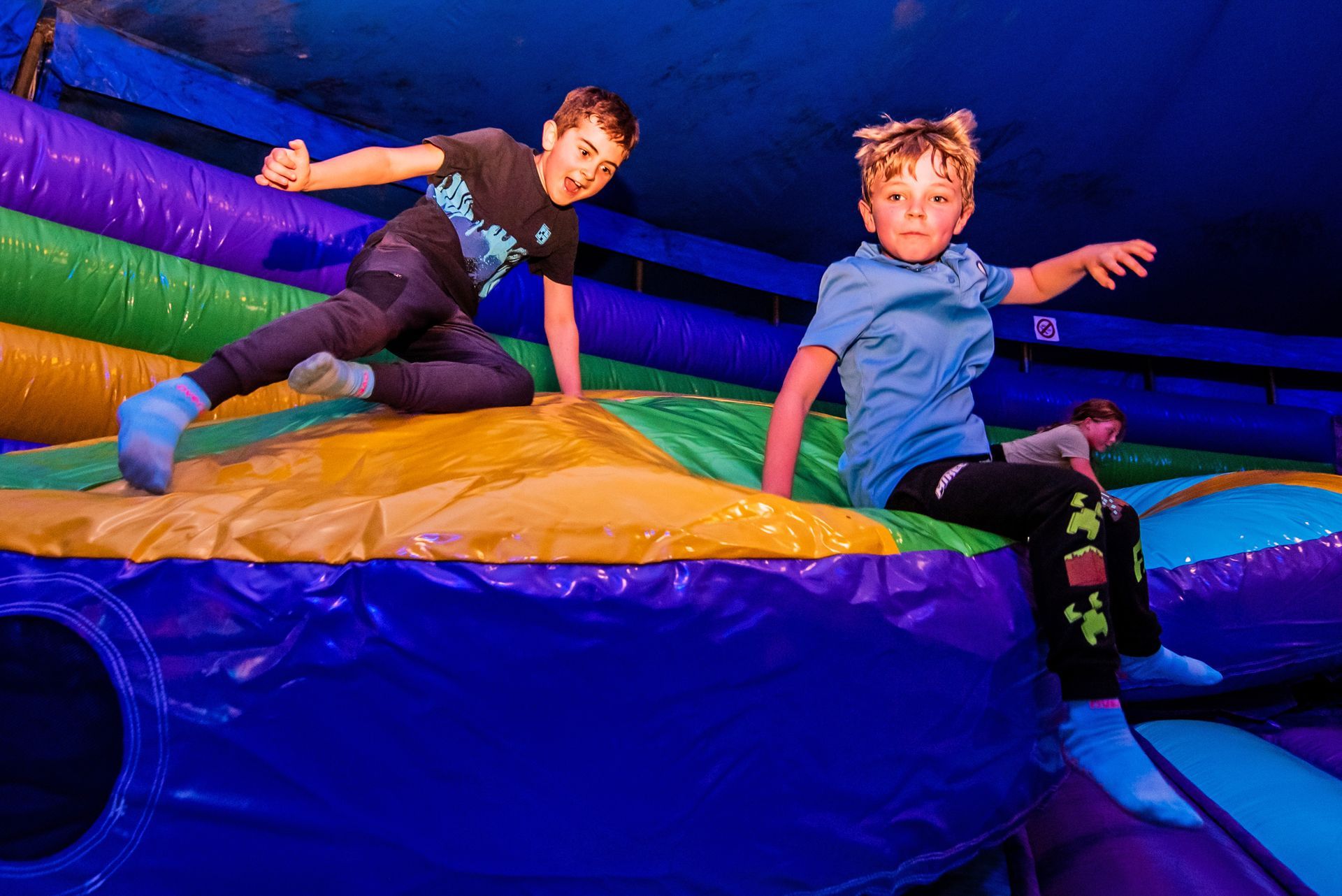 Two girls on colourful inflatable