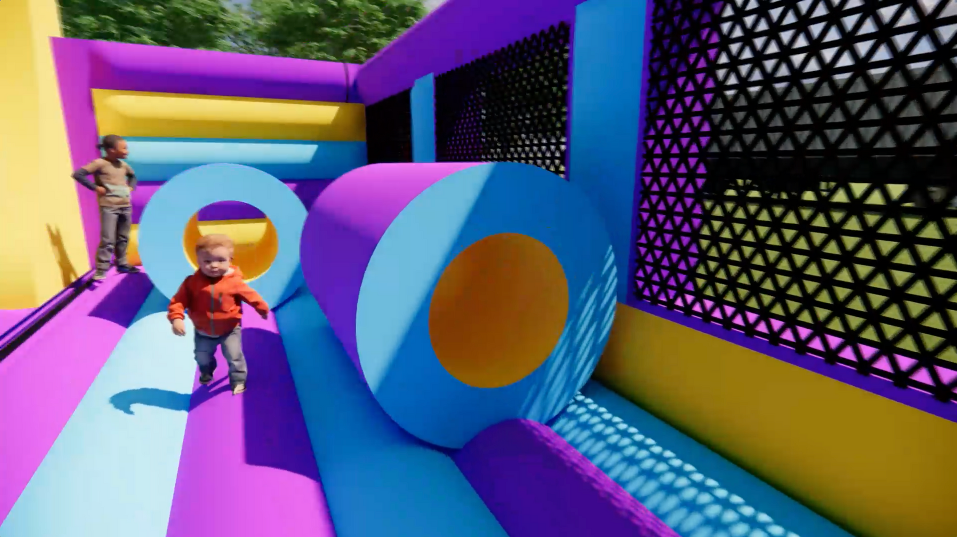 A little boy is playing in a colorful bouncy house.