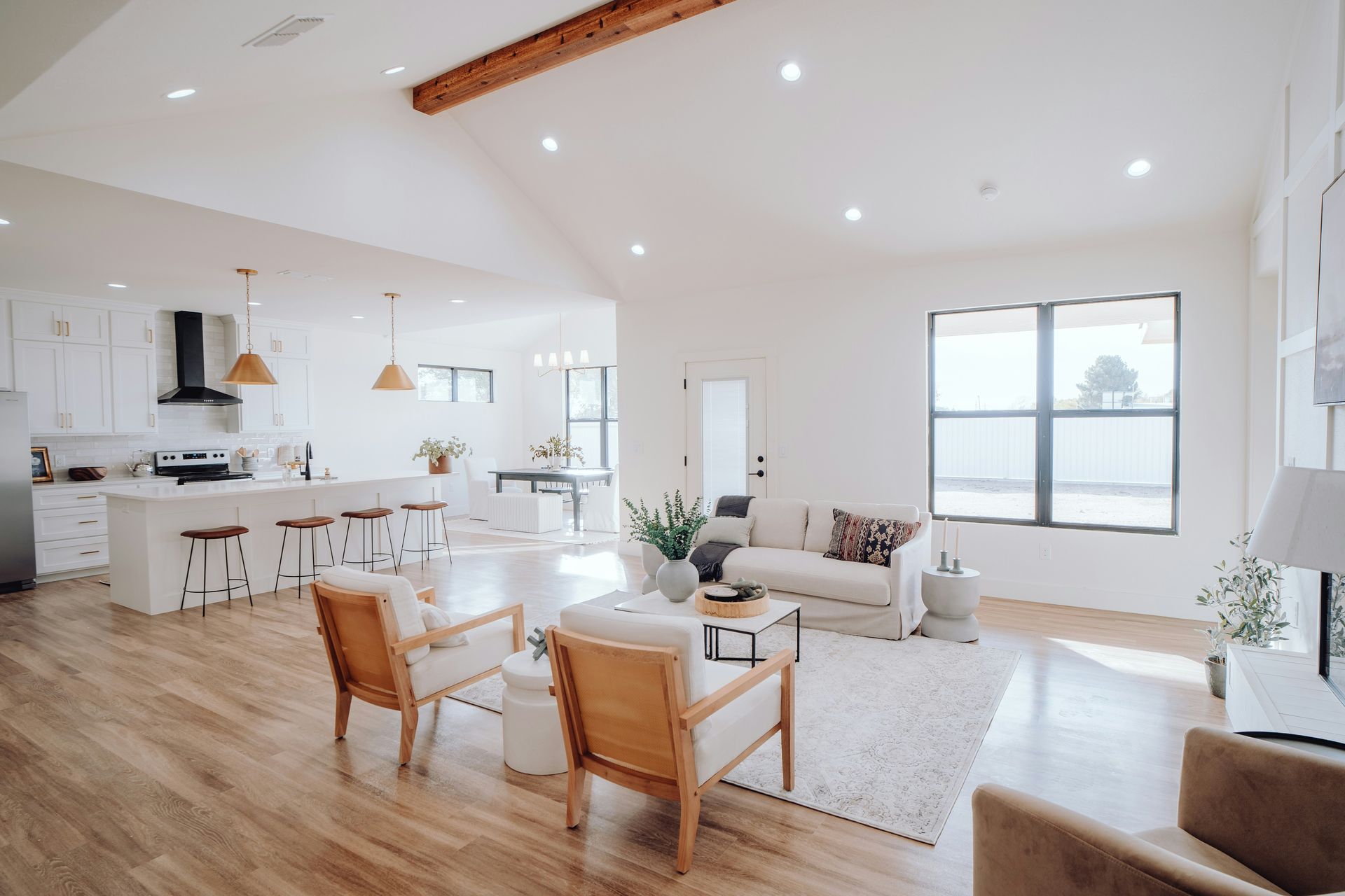 A living room with a couch , chairs , and a table.