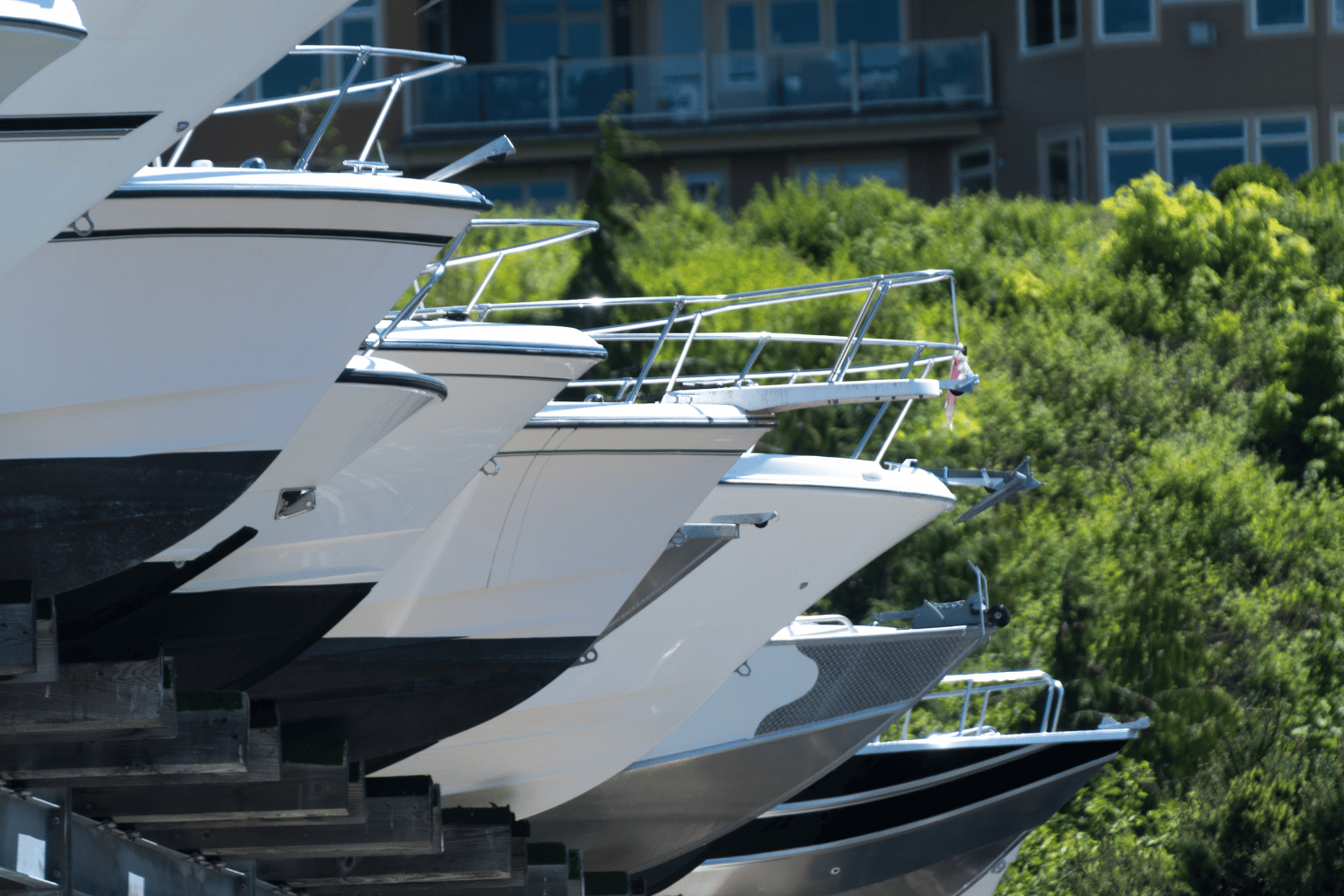 A row of boats are lined up in a row in front of a building.