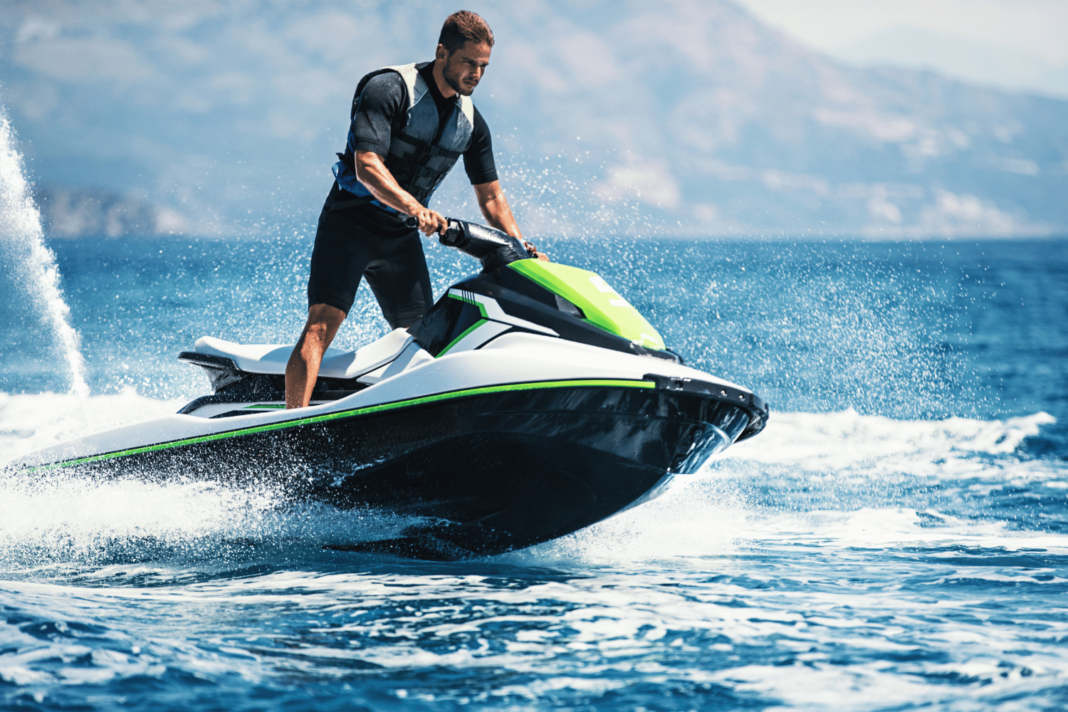 A man is riding a jet ski in the ocean.