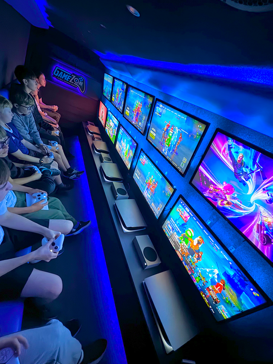 ten kids playing games in a gamezone events gaming bus