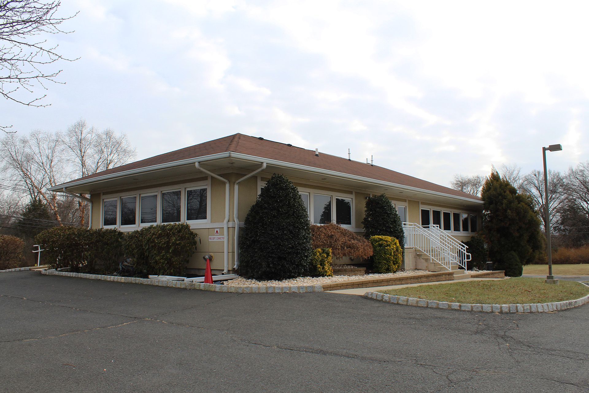 A house with a red roof and a lot of windows